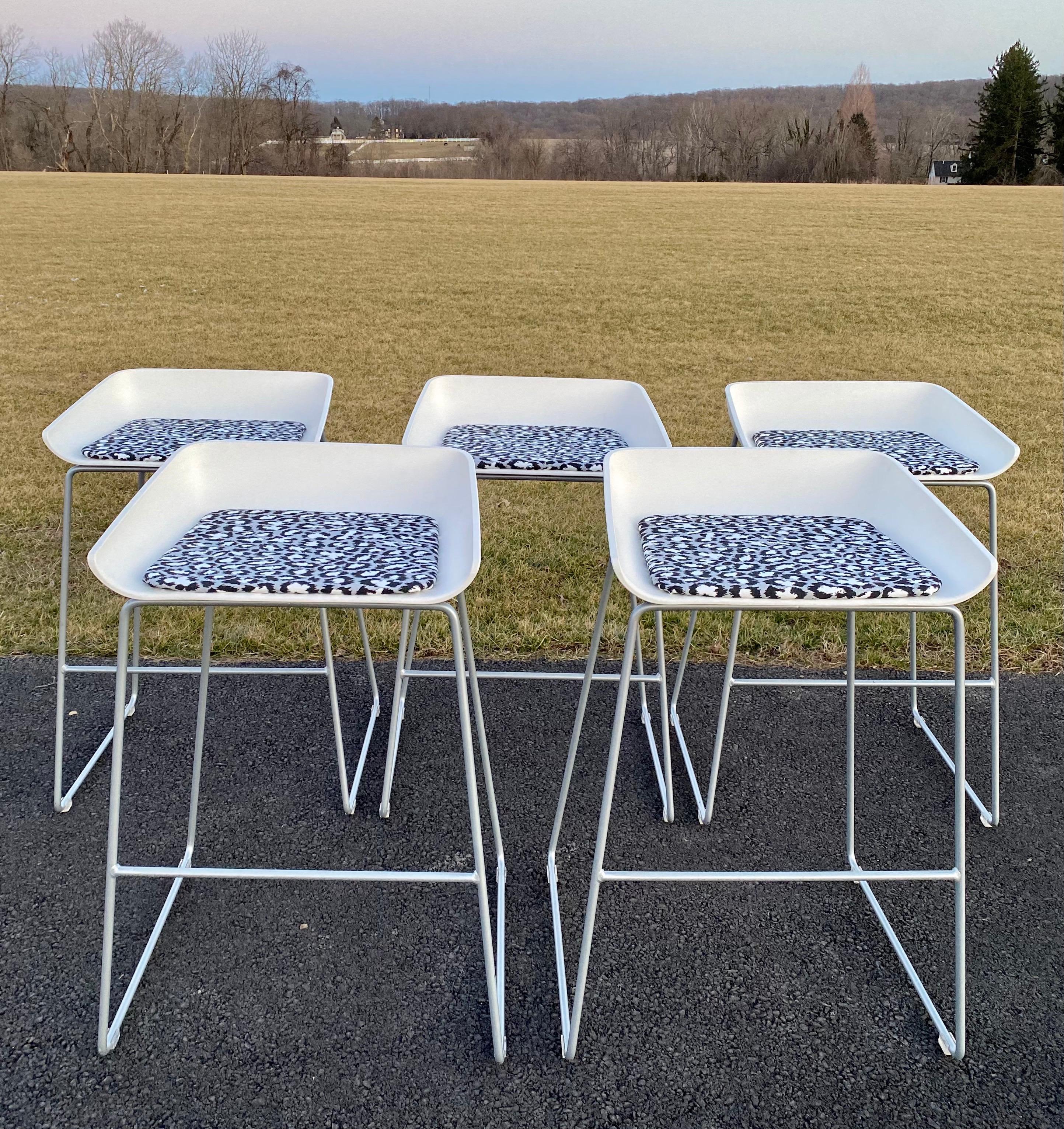 Sculptural Turnstone modern scoop bar stools with newly upholstered cushions using Diane Von Furstenberg white and black leopard “Spotted Cat” print fabric. The DVF abstract fabric gives these geometric cubist style stools an edgy high fashion