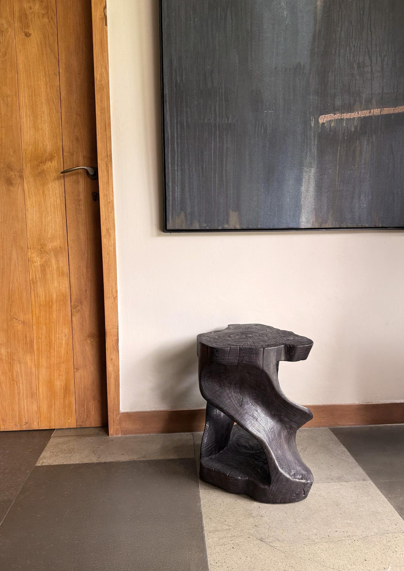 A wonderfully sculptural stool, with a mix of wood textures and shades. It features a spiral design, with an exposed core. A uniquely sculptural and versatile piece, this chair was crafted from a single block of mango wood and has a smooth texture.