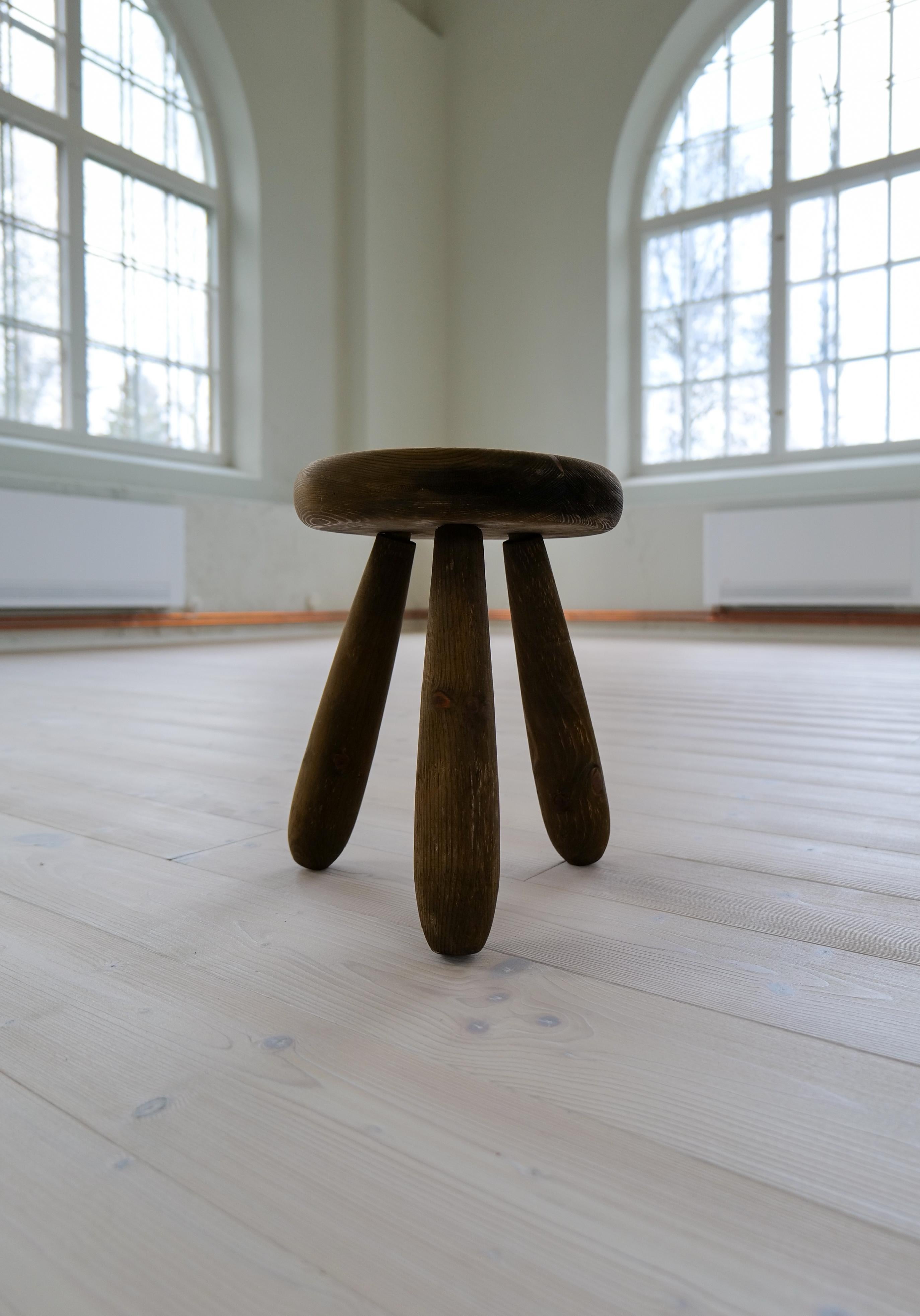 A stool in stained solid pine with rare complexity in the different colors of the wood.
This stool is a good example of the good craftsmanship and minimalistic stile to come in Scandinavian furniture. 

 Very good original condition with a beautiful
