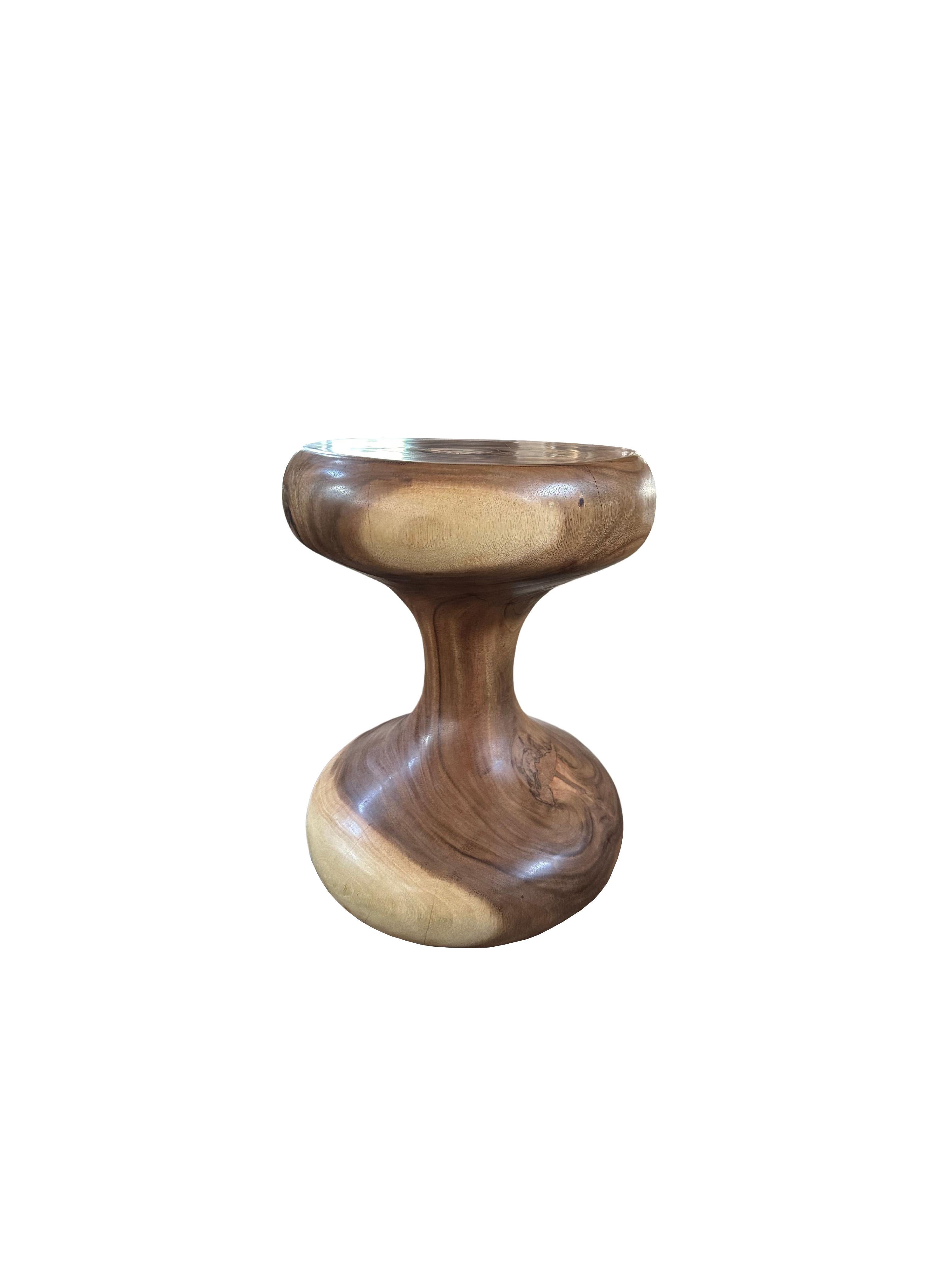 A wonderfully sculptural side table crafted from Suar Wood. Its curved edges and abstract form add to its charm. The perfect object to bring warmth to any space. 