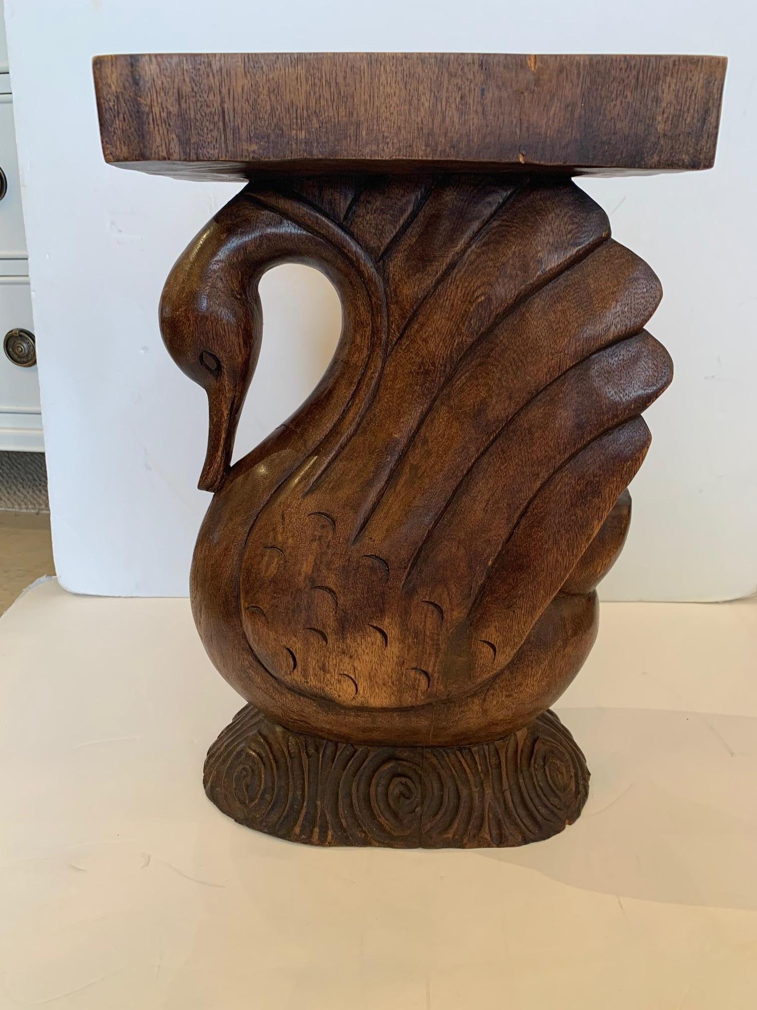 A lovely carved wood side or drinks table with rectangular top and sculptural swan form base.