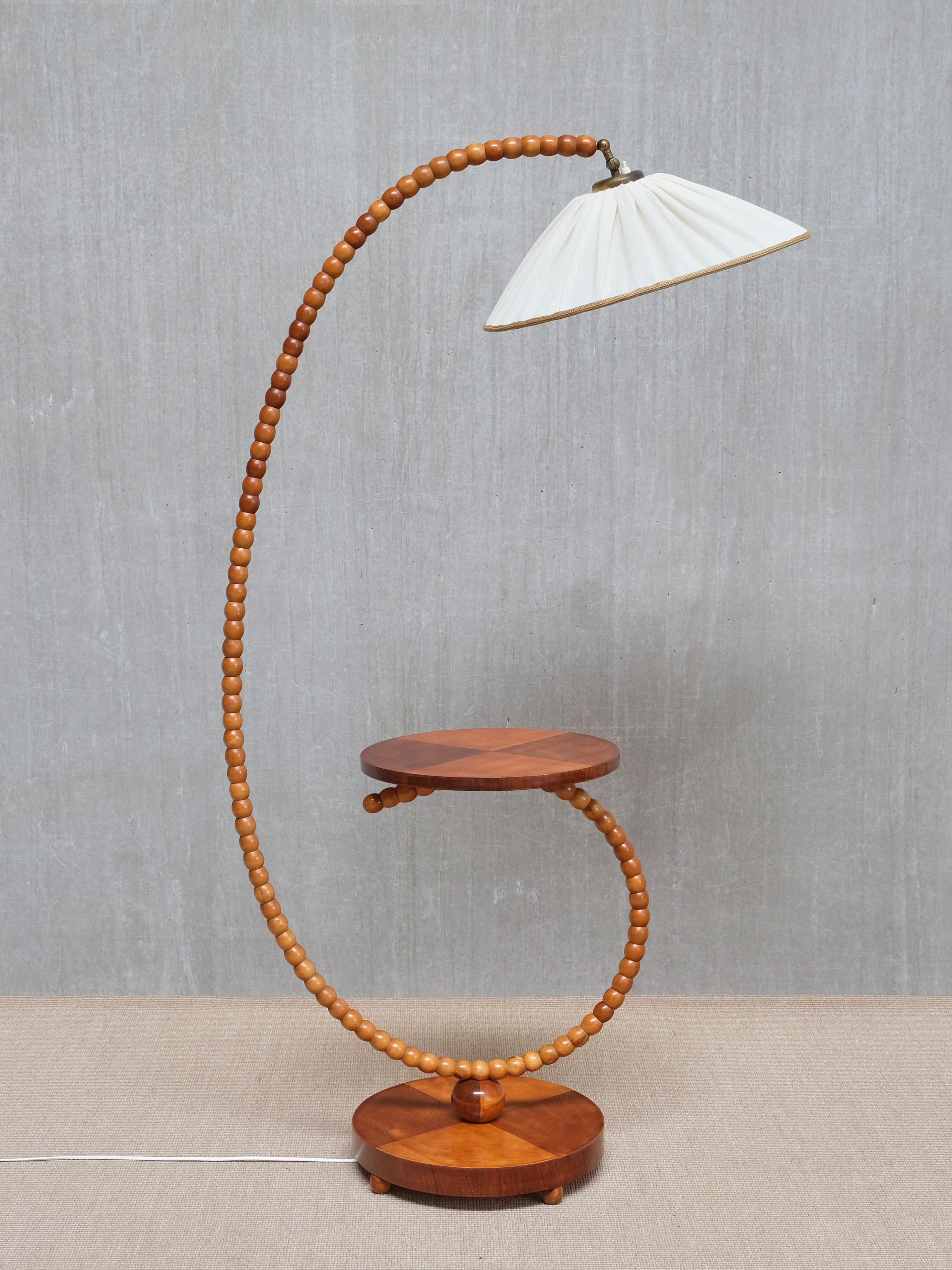 This exceptional sculptural floor lamp was crafted in Sweden in the late 1930s, representing a rare example from the transitional period between Swedish Art Deco Functionalism and the emerging Swedish Modern movement. It combines balanced