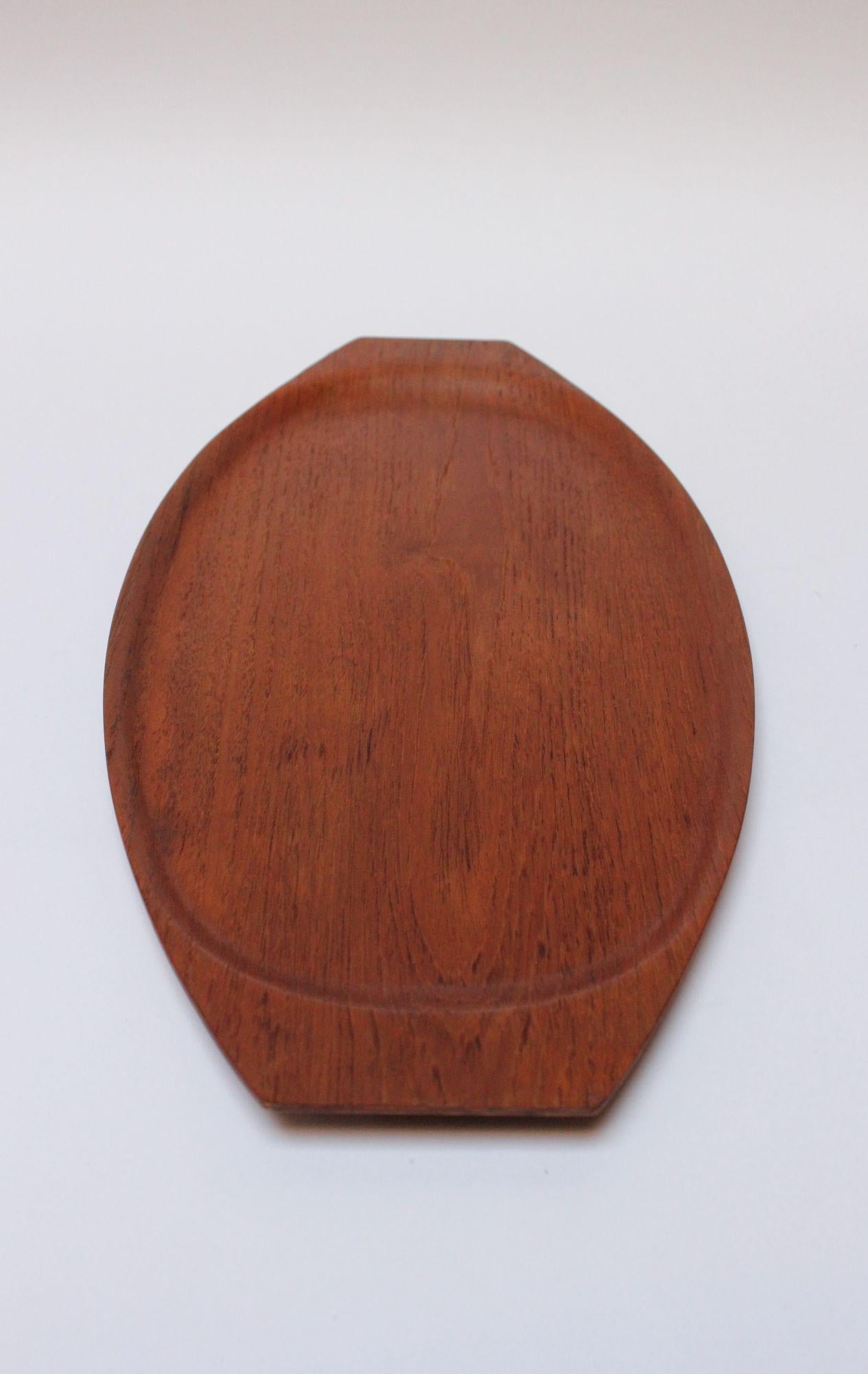 Gondola-form teakwood tray manufactured in the 1960s by Tapio Wirkkala for Kalmar of Sweden. 
Elegant, graceful form with rich color and vibrant teakwood grain. 
Conservatively refinished condition with only one spot of edge wear, as