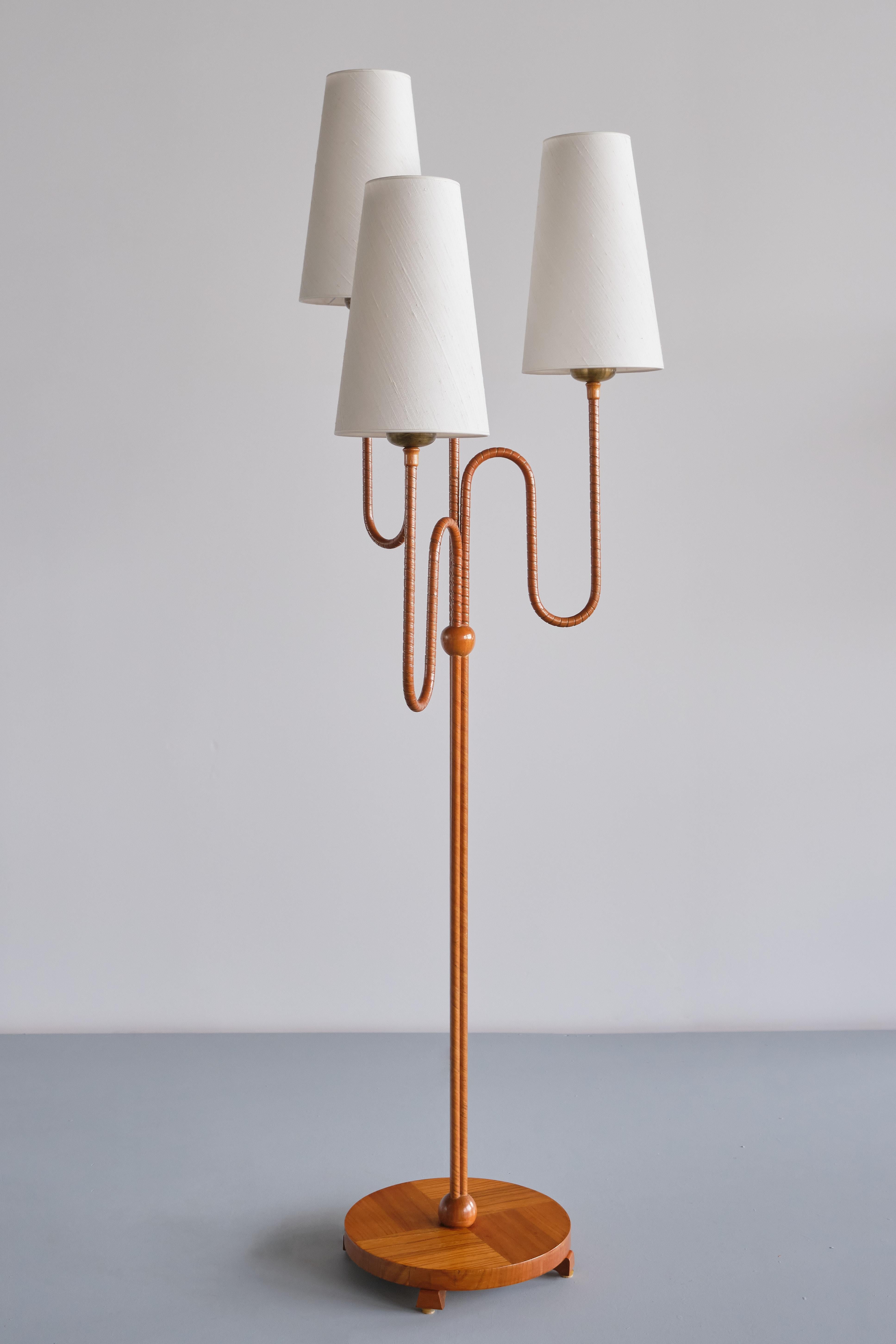 This very rare three arm floor lamp was designed and produced in Sweden in the 1930s. The lamp has been attributed as an early Harald Notini design for Arvid Böhlmarks Lampfabrik. With its sculptural arms and organic shape, the lamp is a great