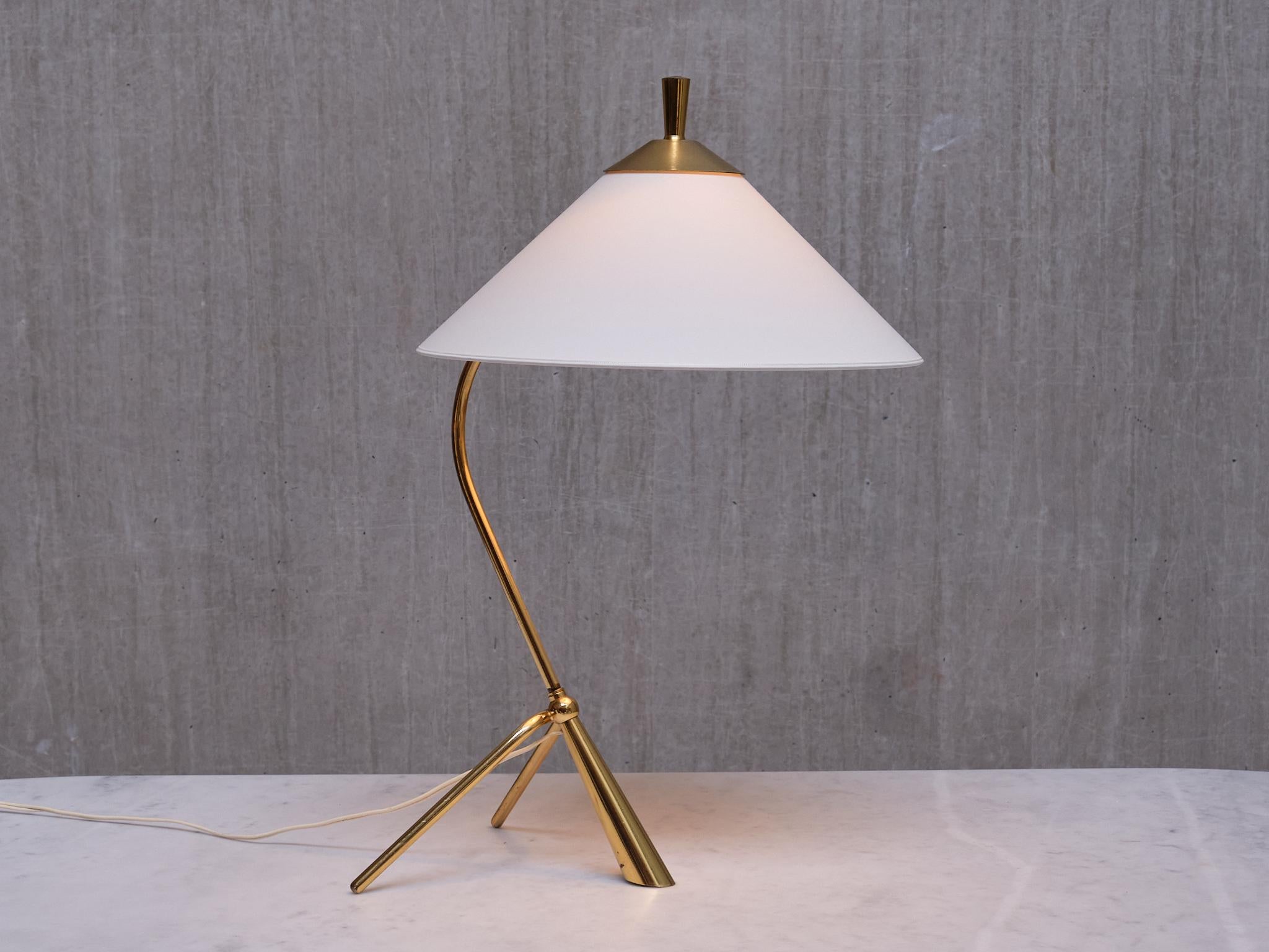 This rare tripod desk or table lamp was produced in Sweden in the 1950s.

The design is marked by the solid brass frame with a three legged base. The combination of curved and diagonal lines of the design give the lamp a striking and elegant