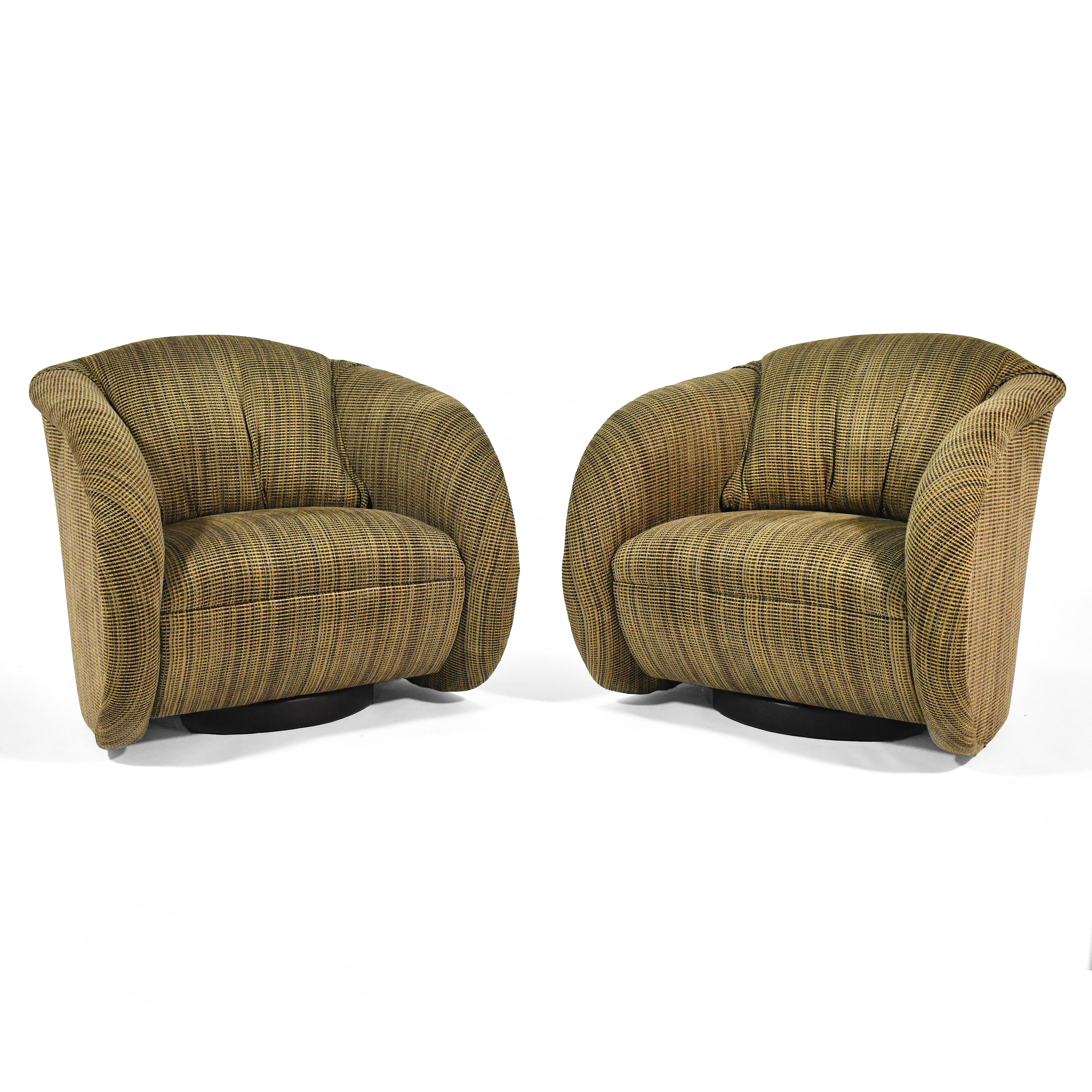 These comfortable and handsome barrel club chairs have a sculptural quality that is very similar to the designs of Vladimir Kagan. They sit on swivel bases with automatic return.

We have four chairs available. Price is per pair.