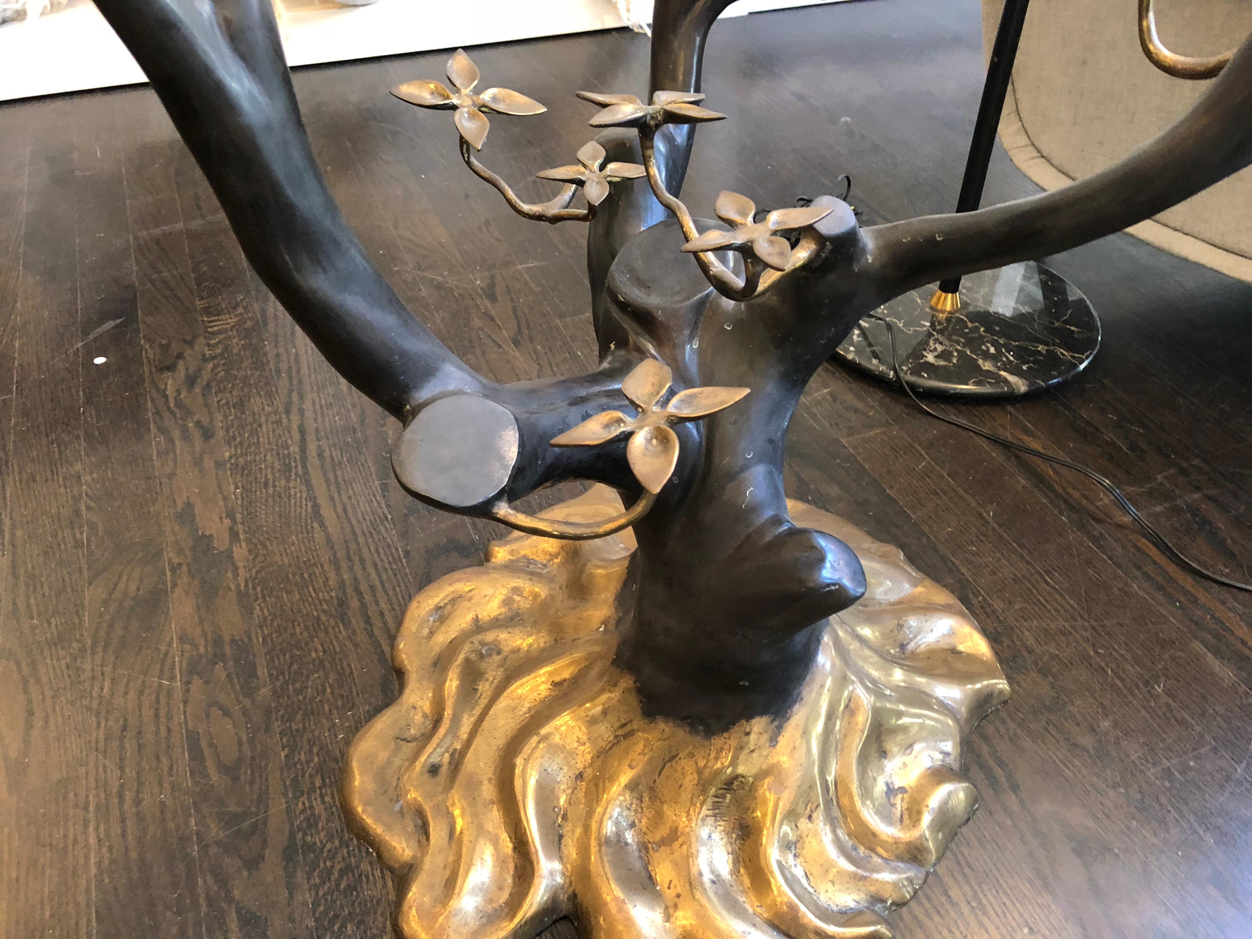 This rare table is made of high quality bronze in the shape of a flowering tree with brass petals. Crafted with a fine eye for detail creating the true feel of trunk, roots and nerves, in a deep brown color with Brass details (leaves). The table has