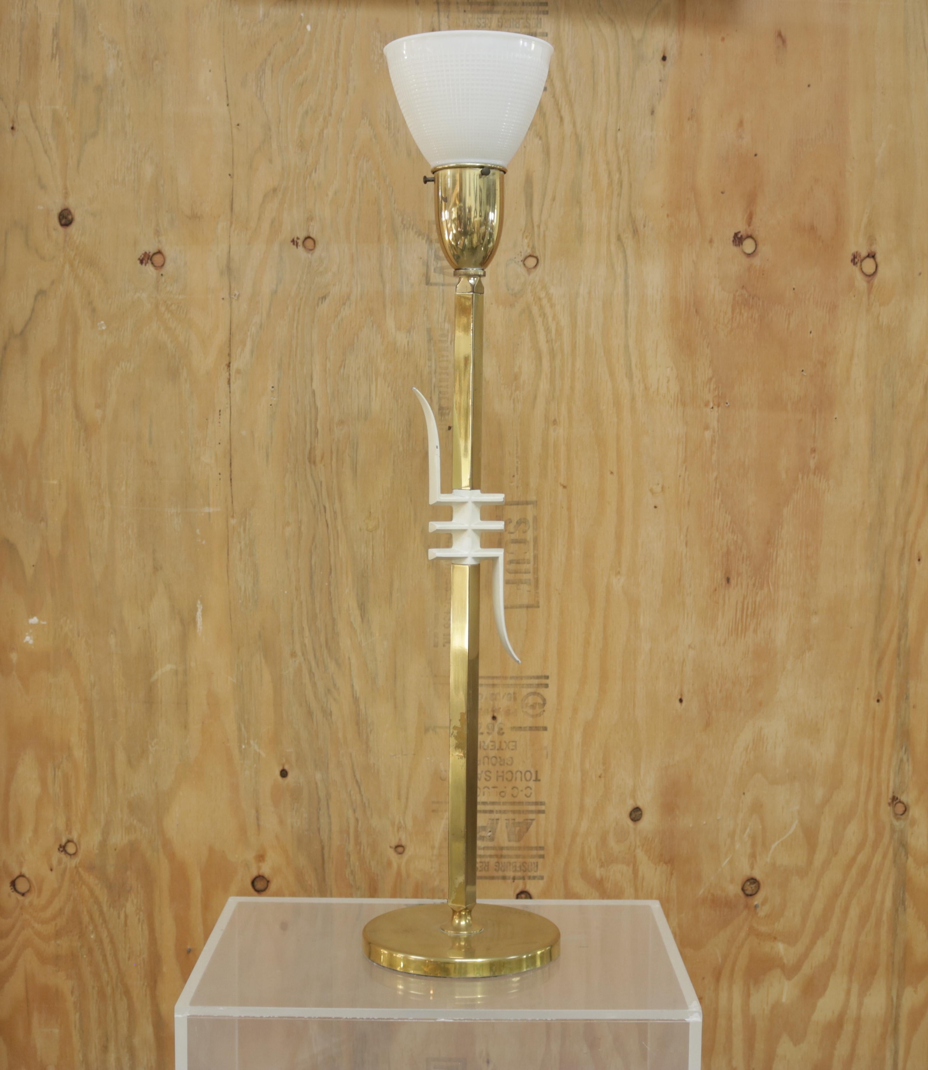 The elegant brass table lamp has a white lacquered wood graphic design with a frosted glass shade covered by a custom order white plastic shade.
The shade is 13.88