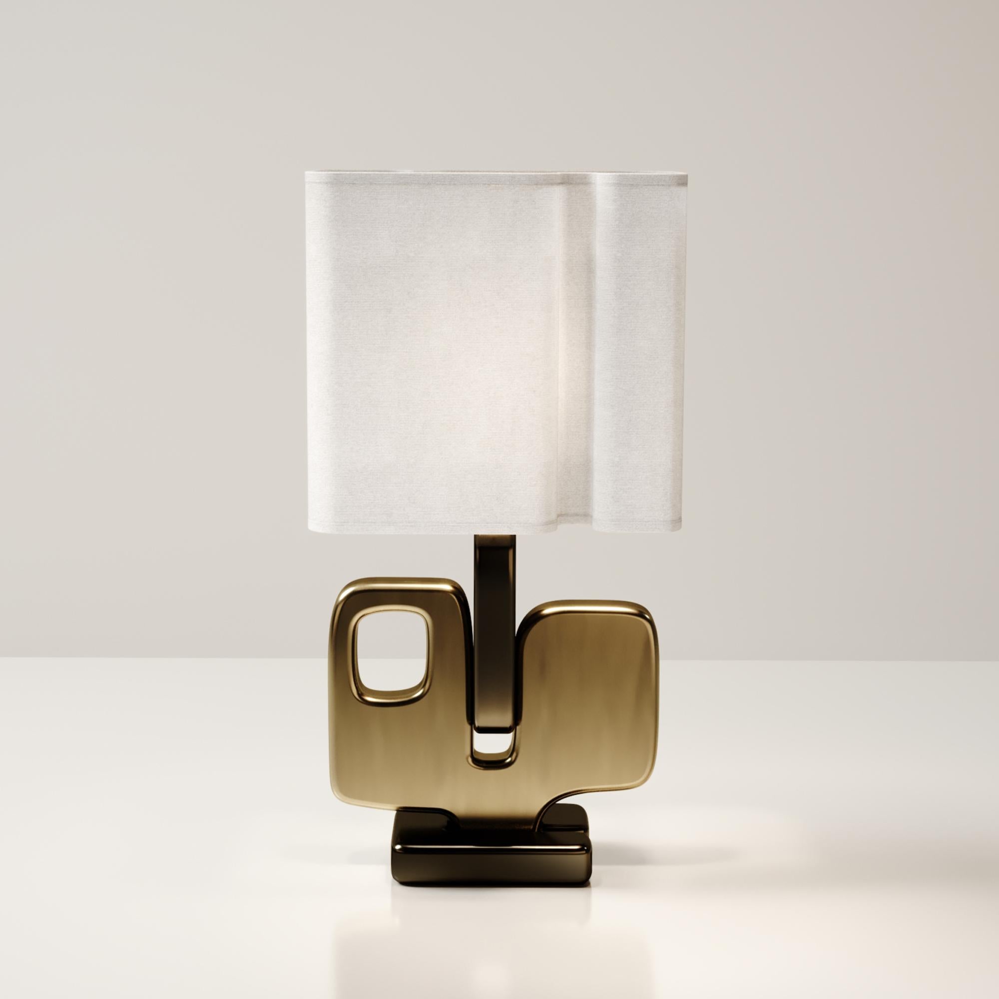 The Apoli table lamp by Kifu Paris is both dramatic and organic it’s unique design. The ethereal geometric and sculptural base is made entirely from bronze-patina brass. This piece is designed by Kifu Augousti the daughter of Ria and Yiouri