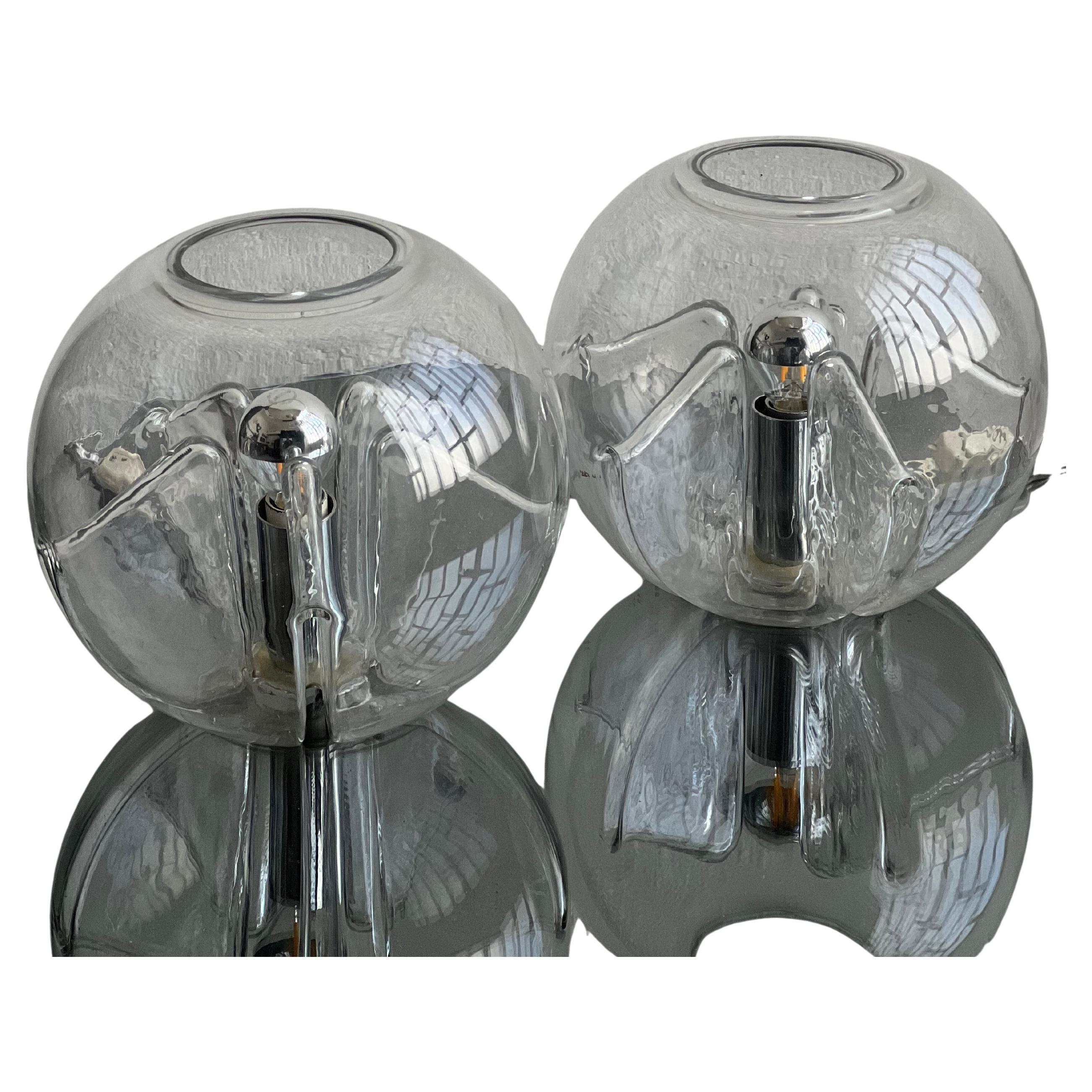 Luminaires du milieu du siècle  - Table en verre de Murano  Lampes - VeArt Collectible Lights

Lampe de table Nuphar conçue par Toni Zucchini et produite par VeArt dans les années 1970.

La lampe a un corps en verre sphérique avec cinq plis repliés