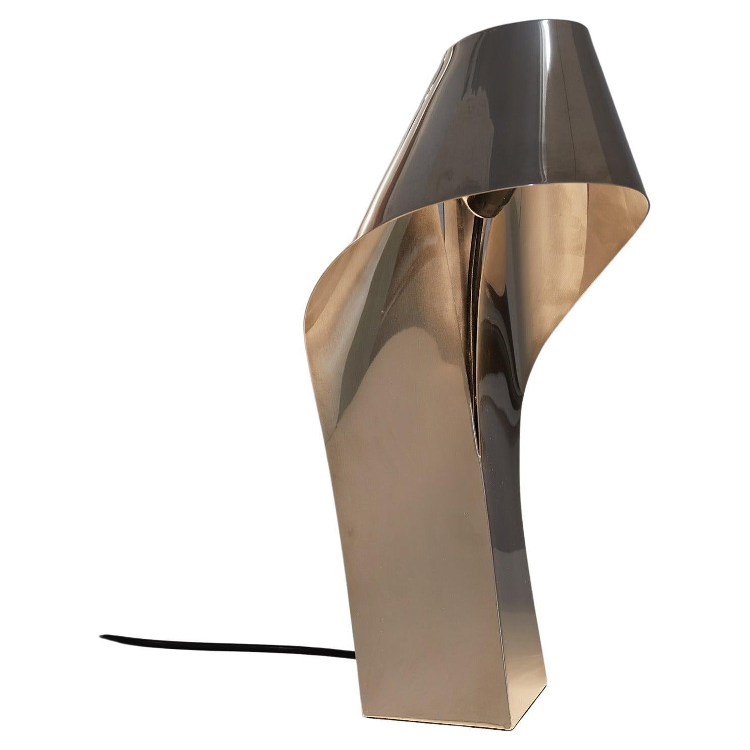 Fantastic table or desk lamp in chromed metal designed by French designer and sculptor Serge Mansau around 1970.

High quality item with beautiful details and a sculptural appearance. Similar in style and quality to certain models by Maison