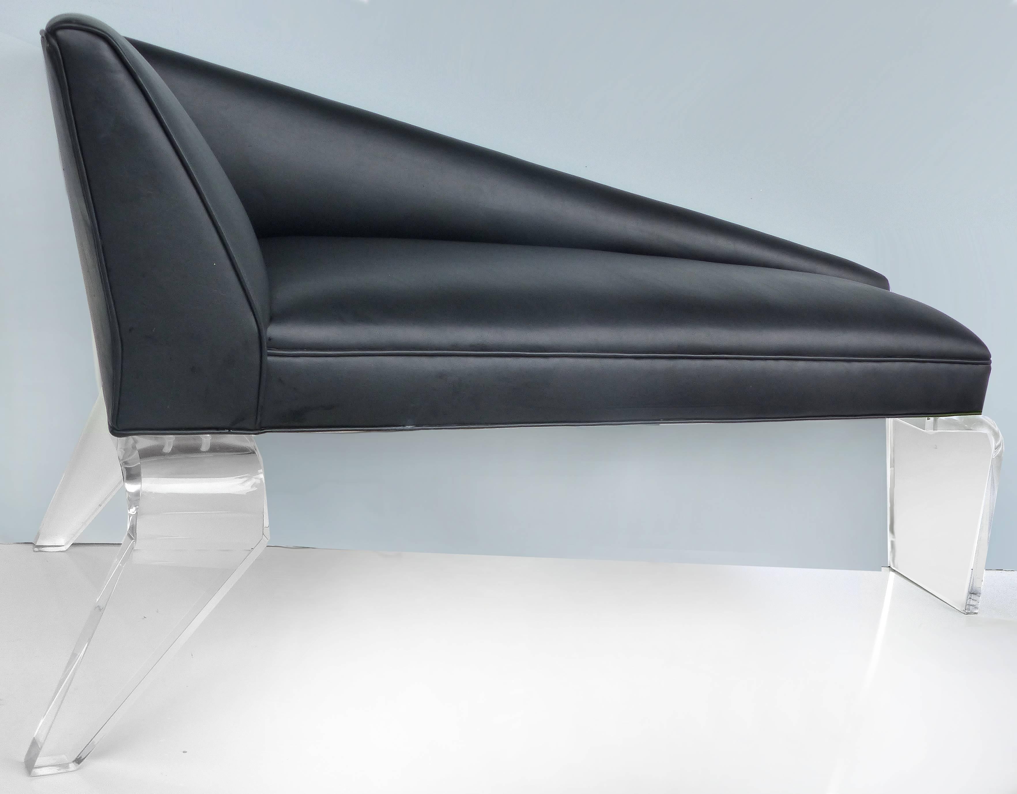 Sculptural Tapered Chaise with Leather Upholstery and Lucite Legs

Offered for sale is an unusual and sleek tapered chaise longue supported by angled Lucite legs in thick Lucite. The chaise is upholstered in black leather with piped edging. Tapers