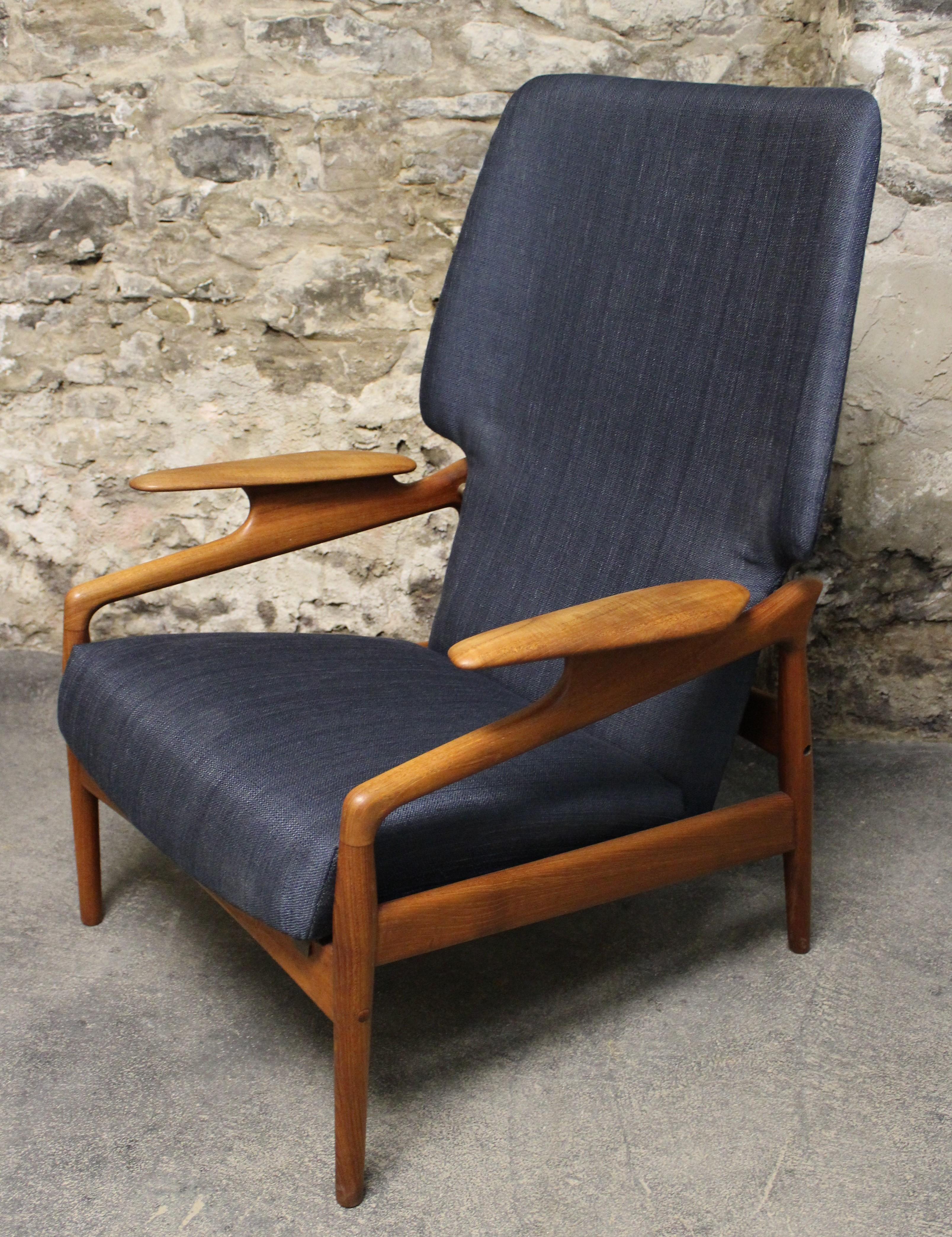 Style meets function with this classic midcentury design by John Bone. Reupholstered in a blue fabric this timeless lounge chair will look good where ever it is placed in a room. This reclining chair has 3 positions it can be set to, please see in