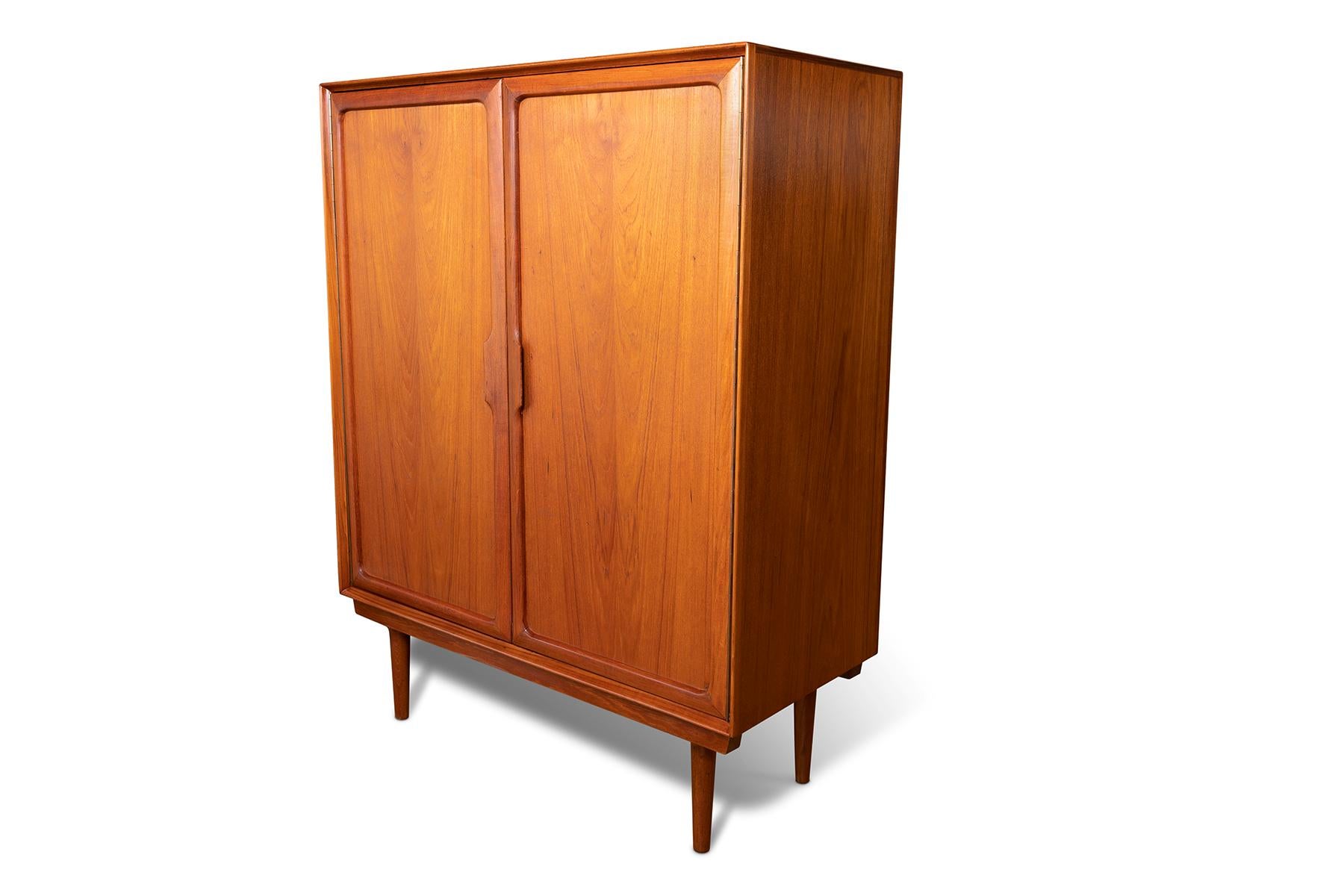 Sculptural teak wardrobe or highboy circa Mid-1960s. This example was purchased from the original owners and has 7 dove tailed interior drawers and beautifully formed solid teak pulls. The work is part of a bedroom set that includes a 9 drawer