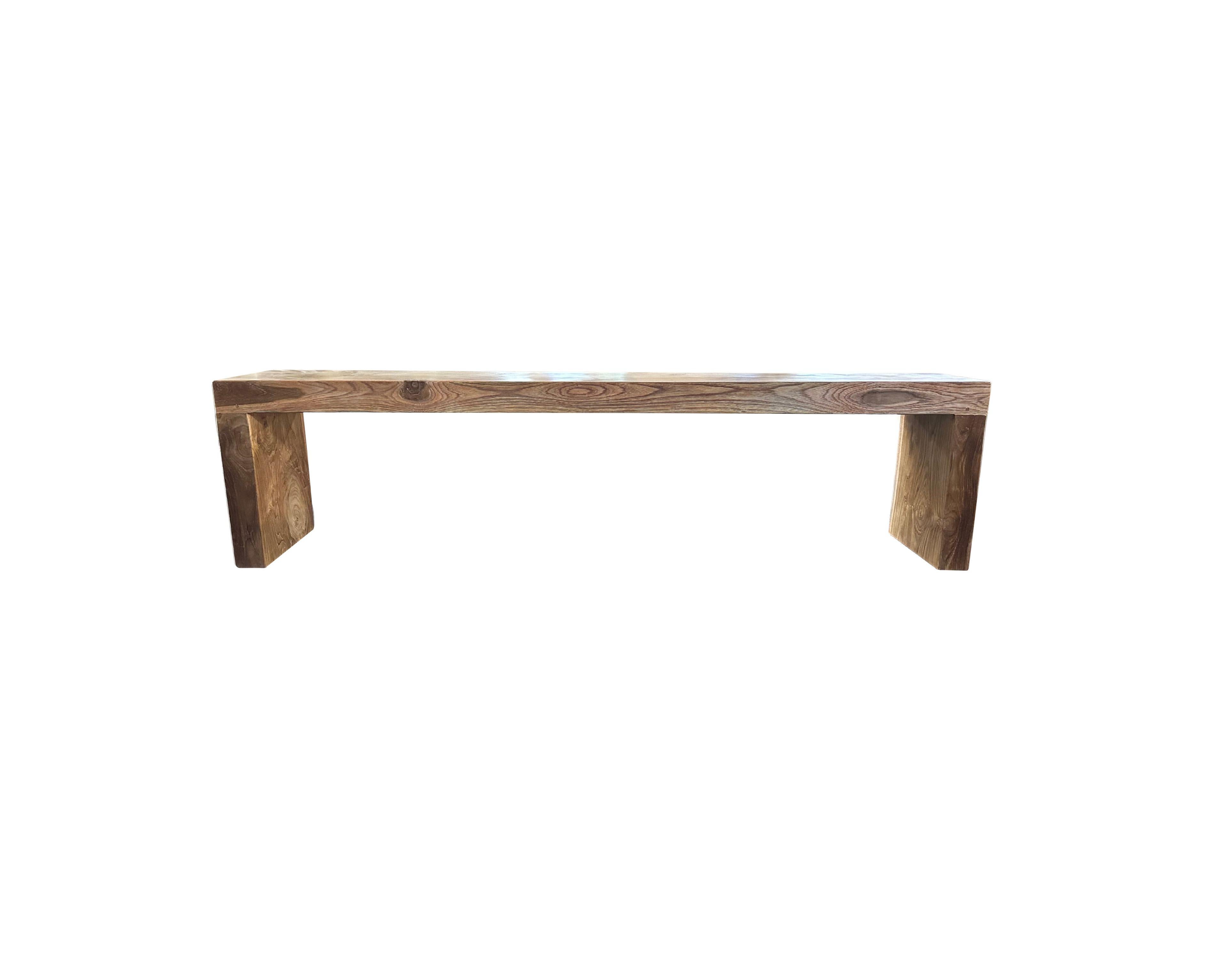 A sculptural hand-carved teak wood bench, a wonderful addition to bring warmth any space.  The table is hand-carved by local artisans using joinery techniques without the use of nails. This bench features an elegant mix of wood textures and shades.