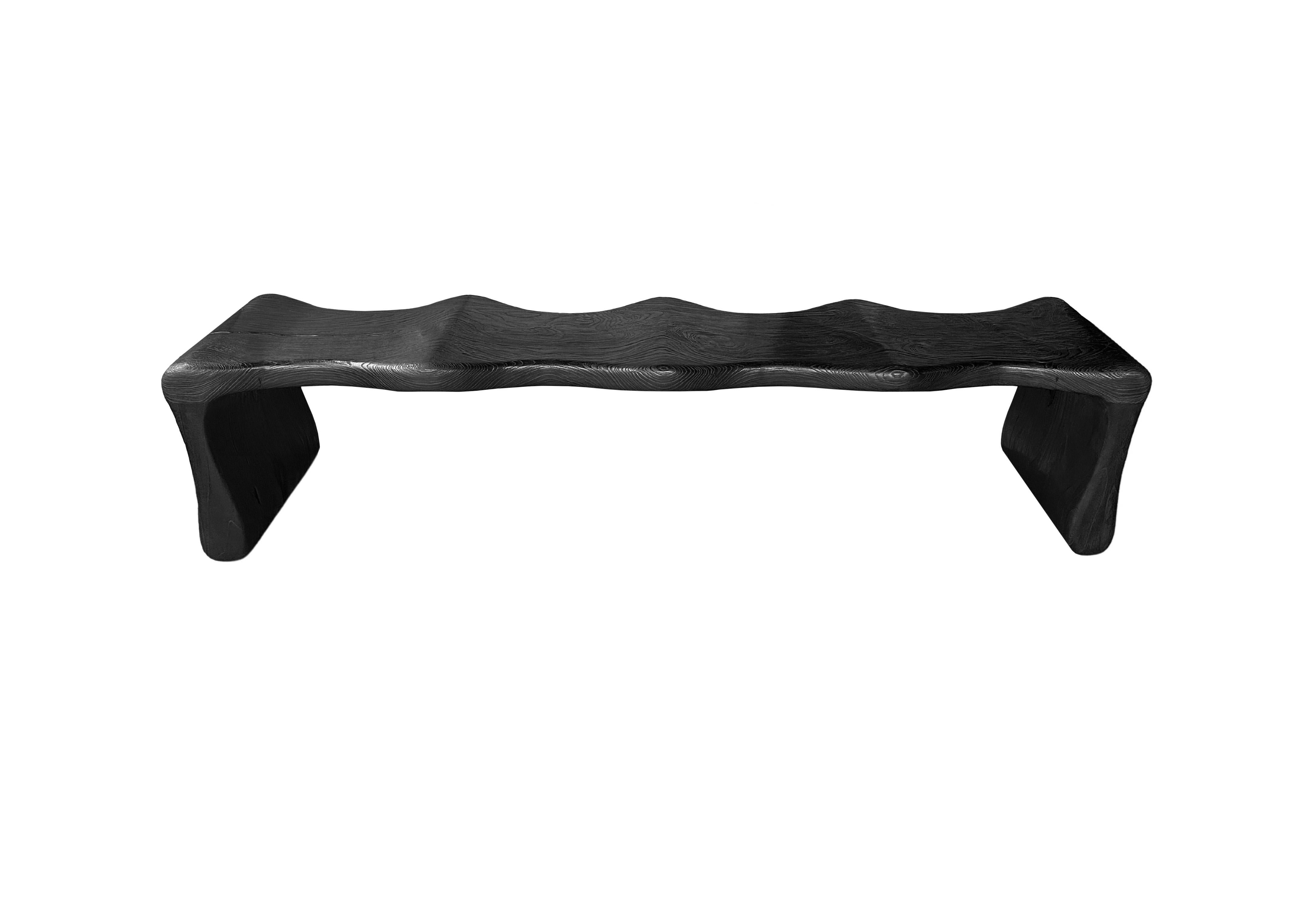 Inspired by the contours of Bamboo, this bench was designed without any straight lines or edges. The bench was meticulously sculpted to the perfect shape from solid teak wood. The wood used to create this bench is reclaimed, sourced from old pillars