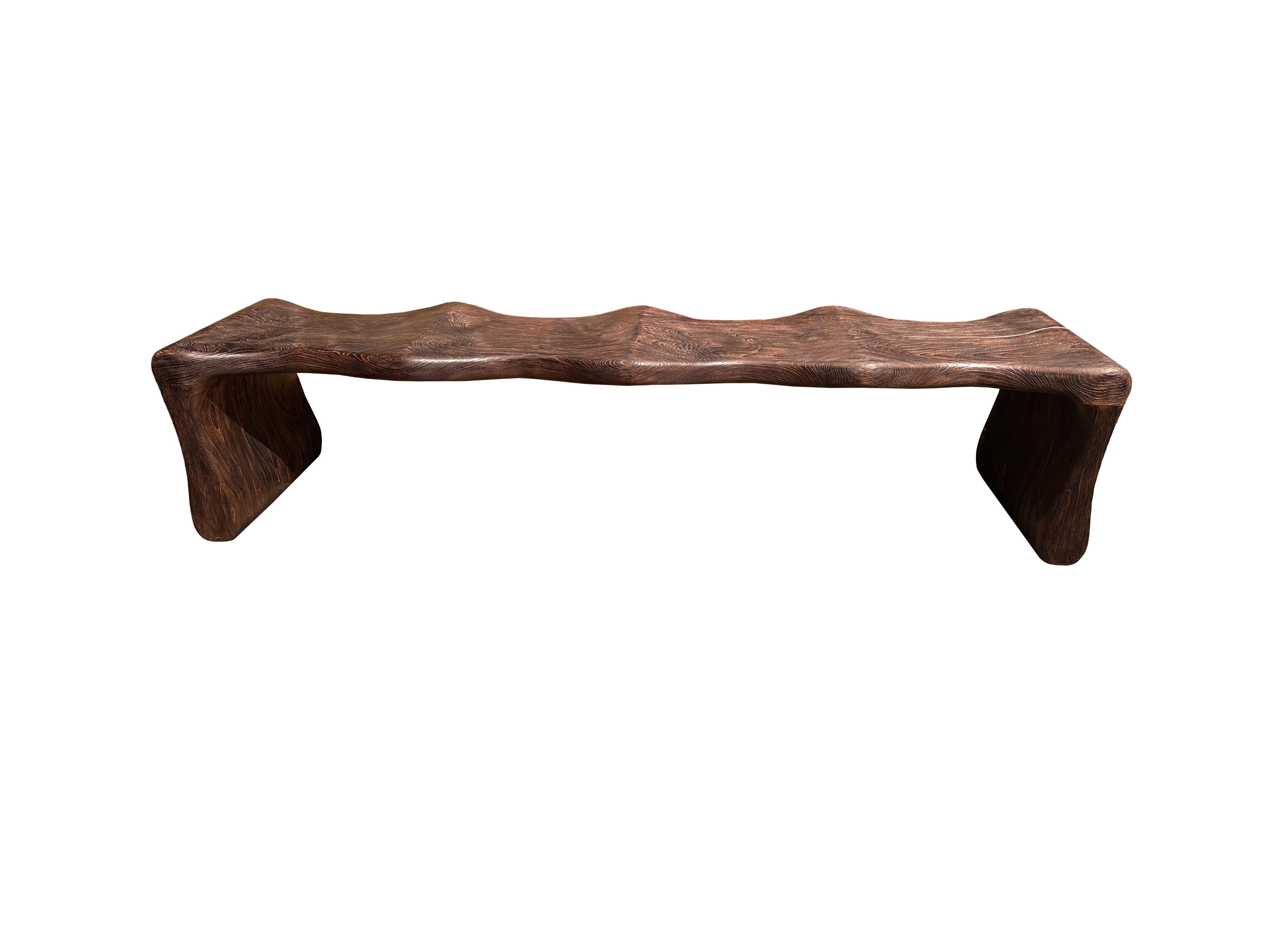 Inspired by the contours of Bamboo, this bench was designed without any straight lines or edges. The bench was meticulously sculpted to the perfect shape from solid teak wood. The wood used to create this bench is reclaimed, sourced from old pillars