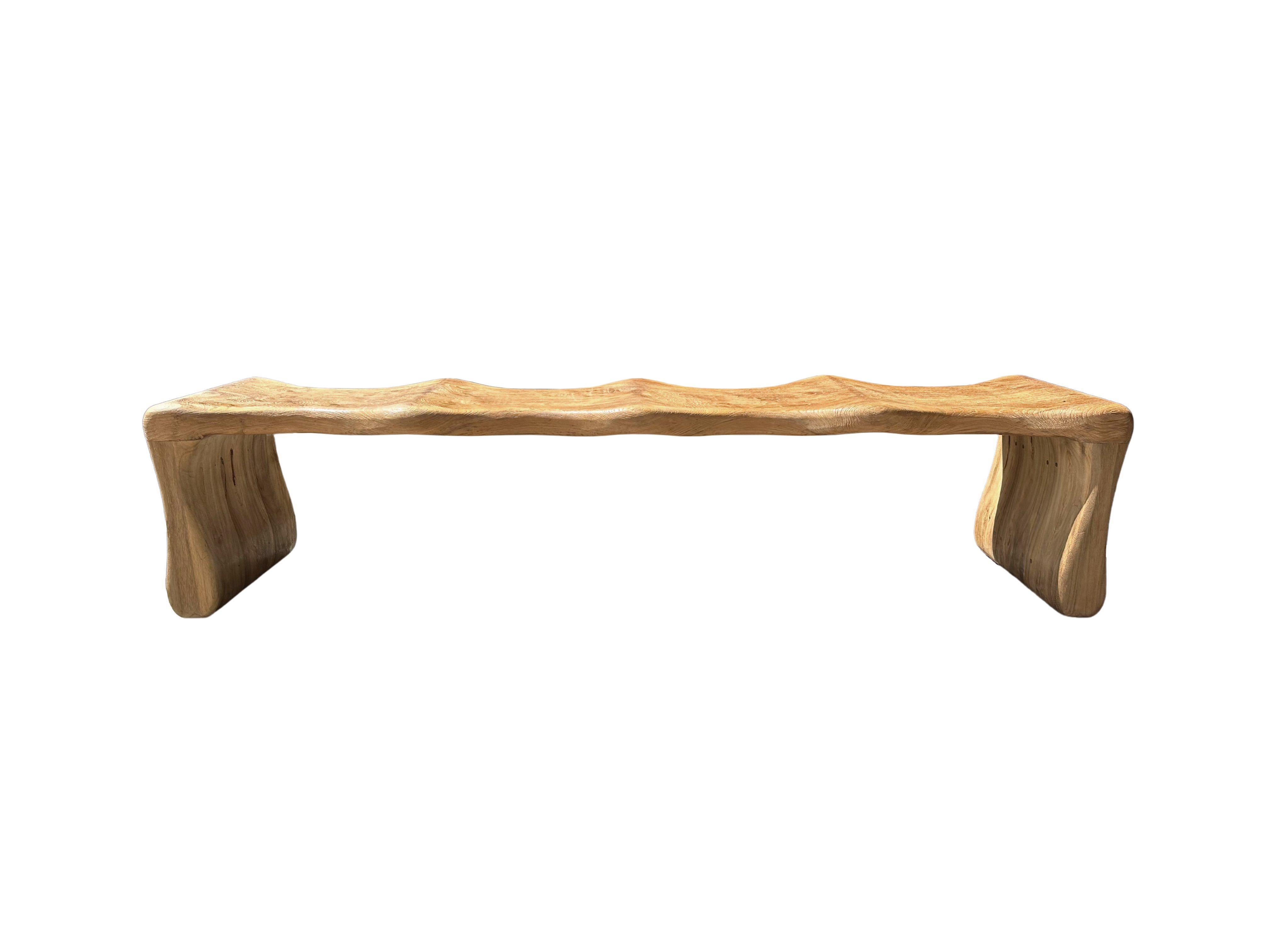 Inspired by the contours of Bamboo, this bench was designed without any straight lines or edges. The bench was meticulously sculpted to the perfect shape from solid teak wood. The wood used to create this bench is reclaimed, sourced from old pillars