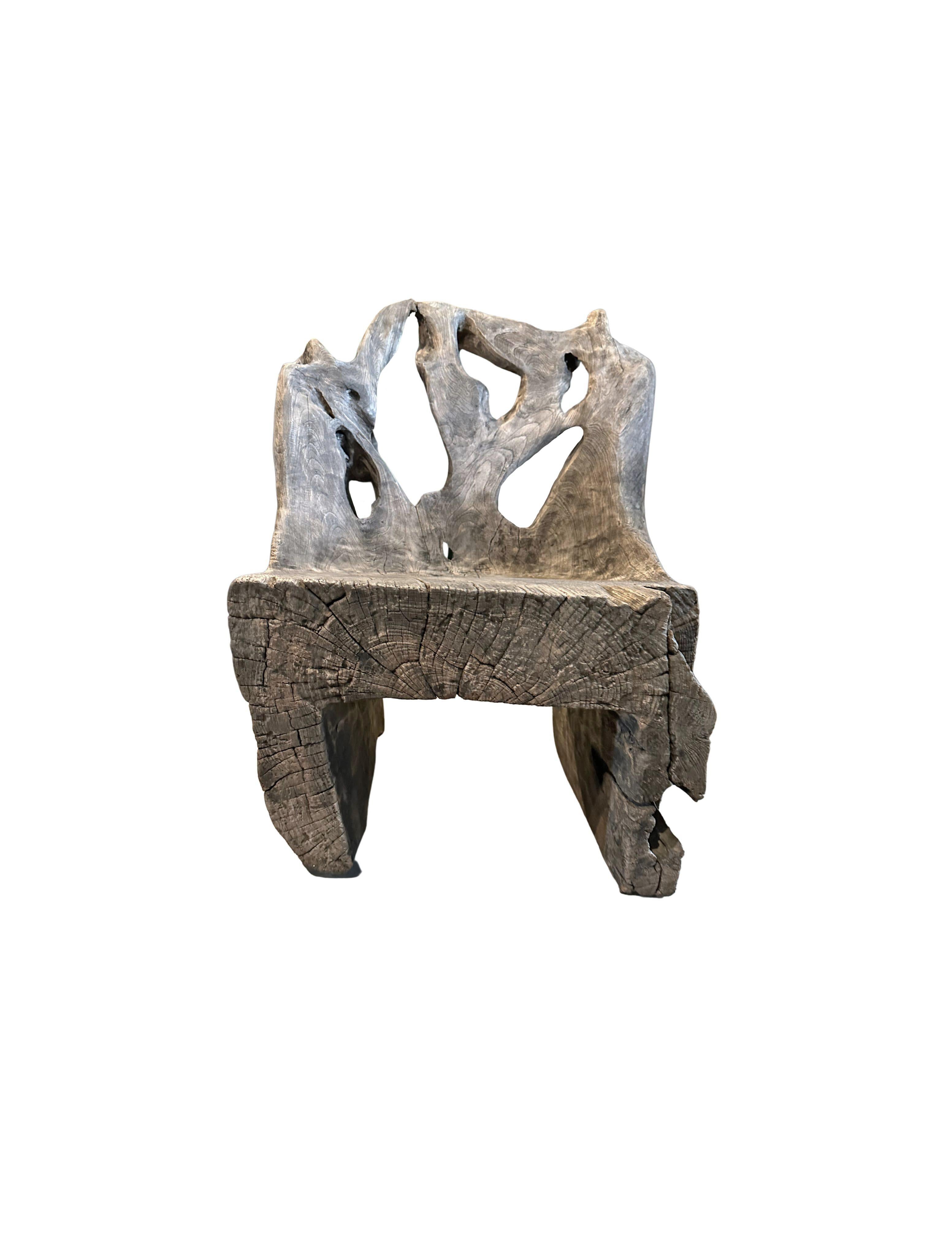 A wonderfully organic and sculptural chair. Carved from a single block of teak wood, this chair features wonderful contours and wood textures. This chair was sourced from bojonegoro on the island of Java. A unique object to bring warmth to any