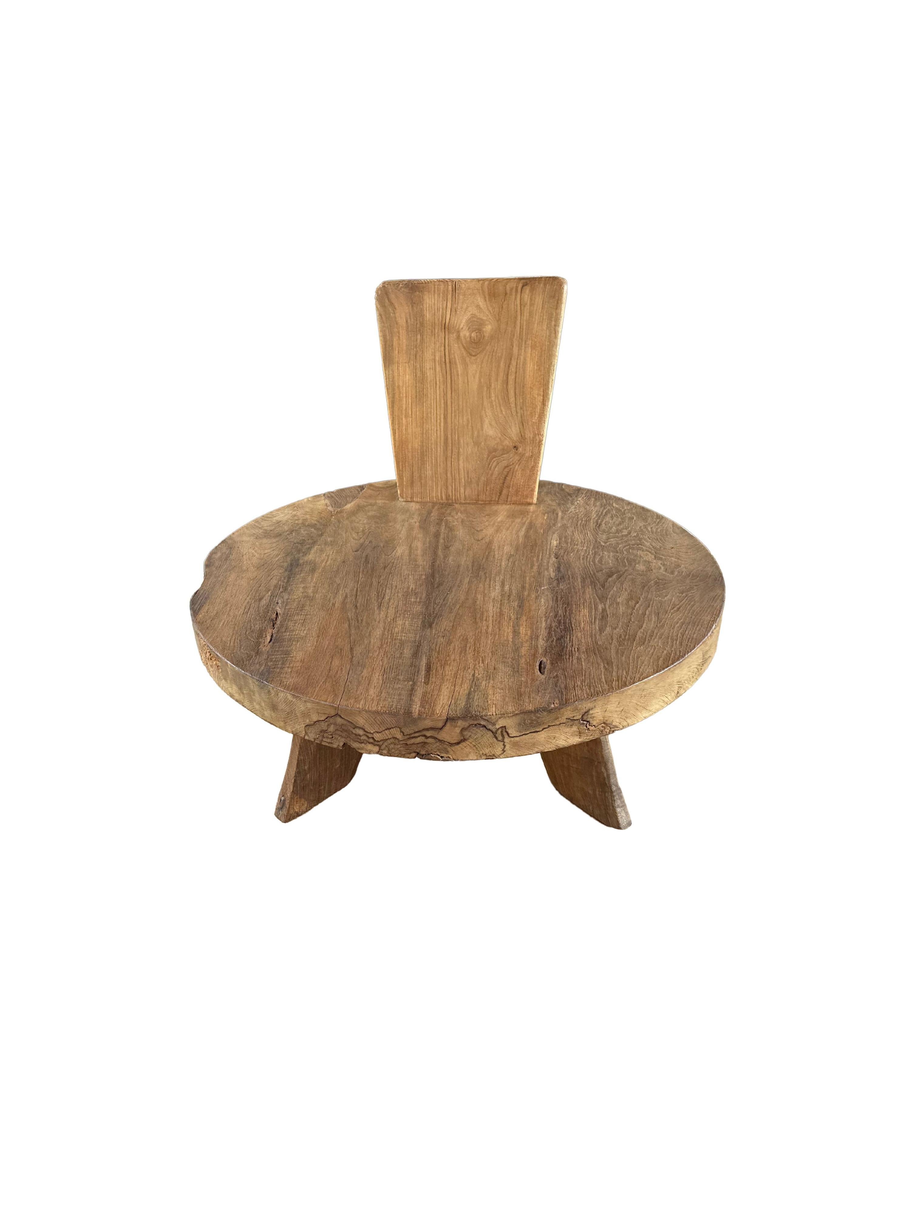 This elegant round teak wood lounge chair exudes timeless sophistication with its graceful, flowing design. Crafted from premium teak, the chair features soft, subtle curves in both its legs and backrest, creating a harmonious silhouette that