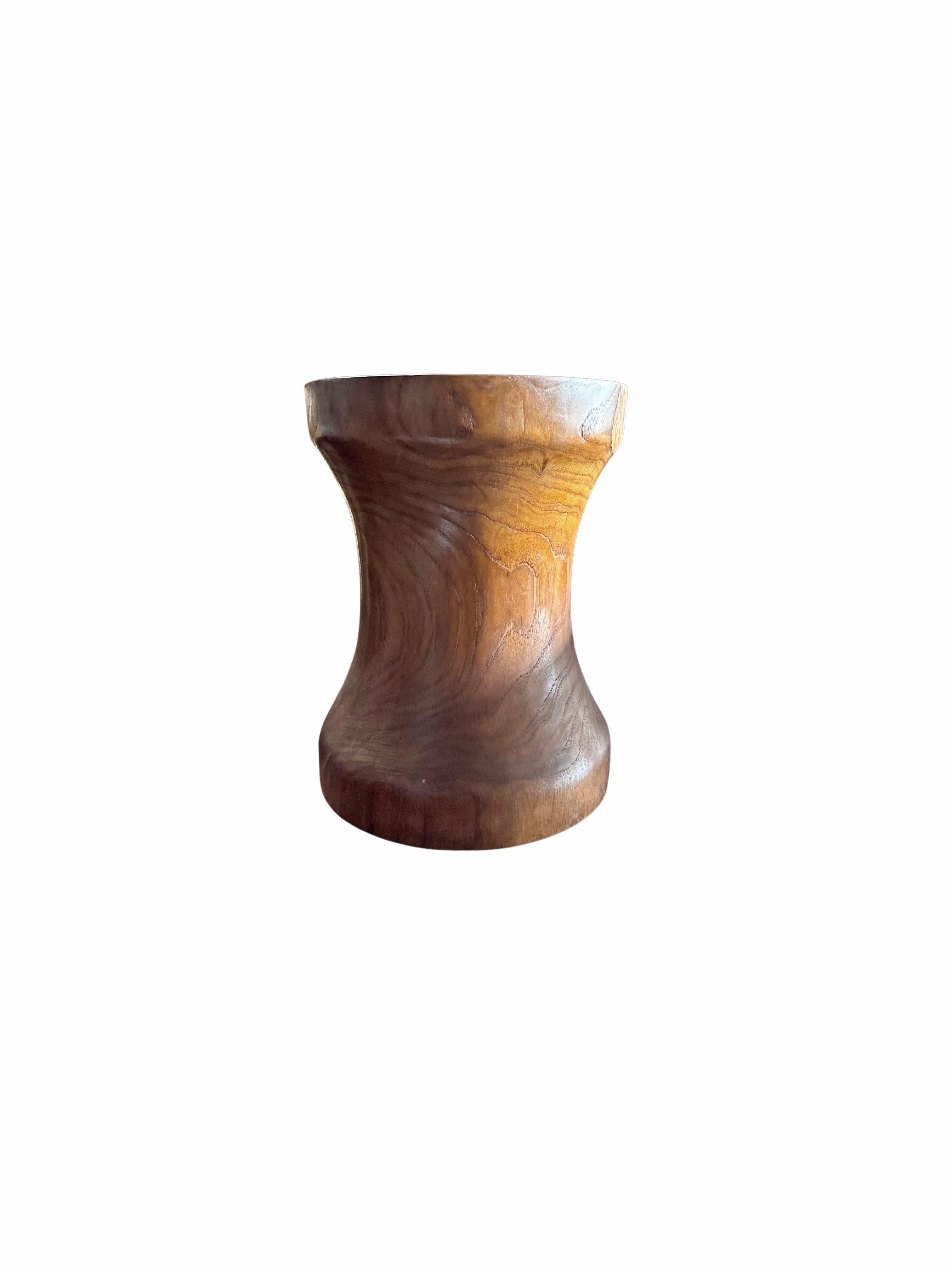 A wonderfully sculptural side table crafted from Teak Wood. Its curved edges add to its charm. This table features a wonderful array of wood textures and shades. The perfect object to bring warmth to any space.
