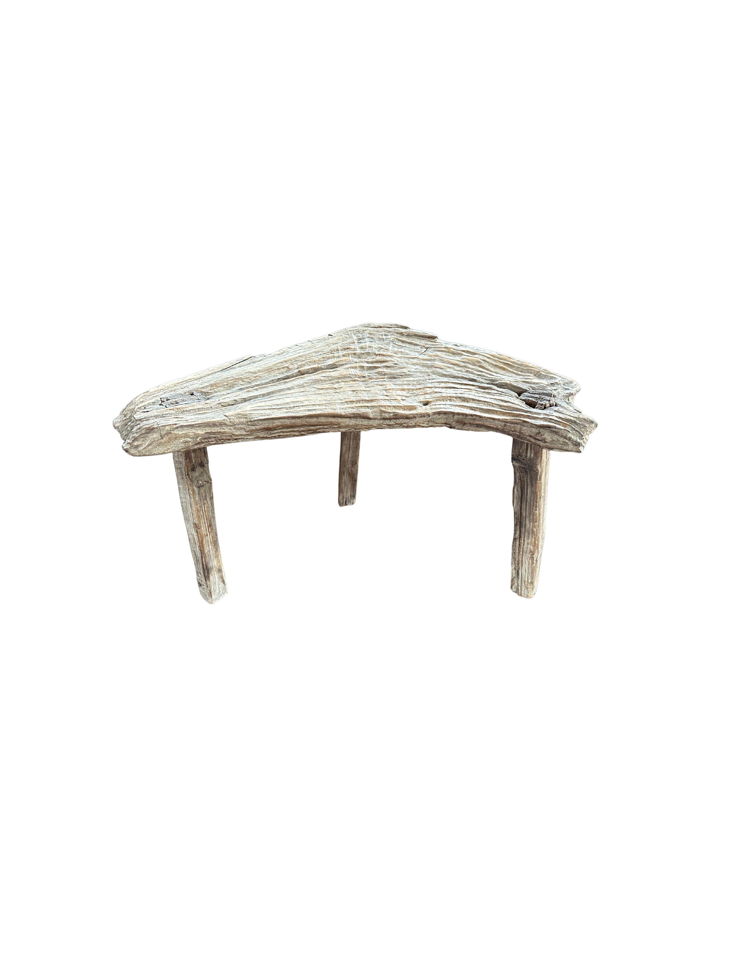 A wonderfully organic and sculptural stool. Carved from teak wood, this stool features wonderful contours and wood textures. This chair was sourced from bojonegoro on the island of Java. A unique object to bring warmth to any space. The age-related