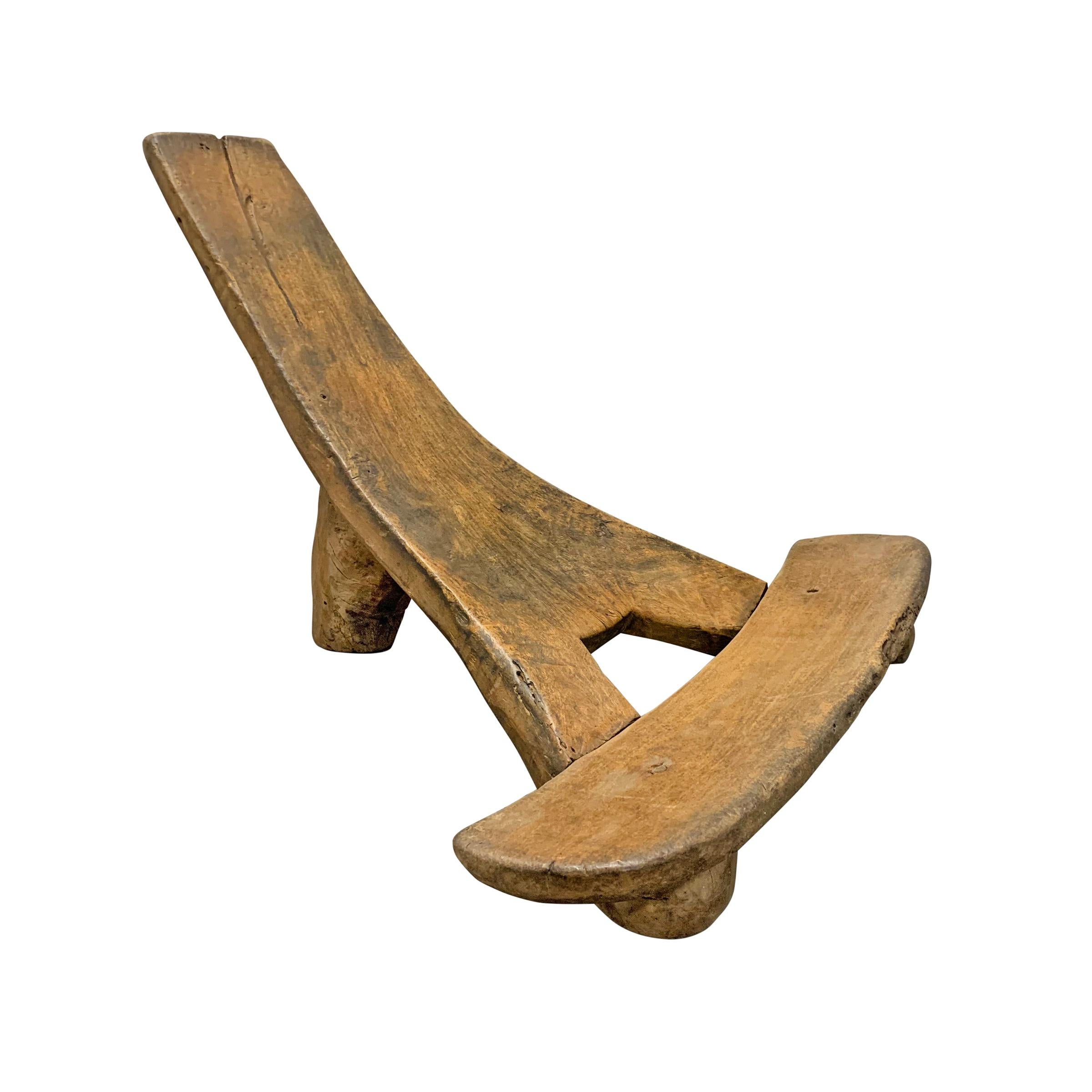 A wonderfully sculptural low chaise from the Tiv people of Nigeria, carved of two pieces of wood with the seat being one piece and the Y-shaped back and leg being another. Excellent modern form and wonderful patina!