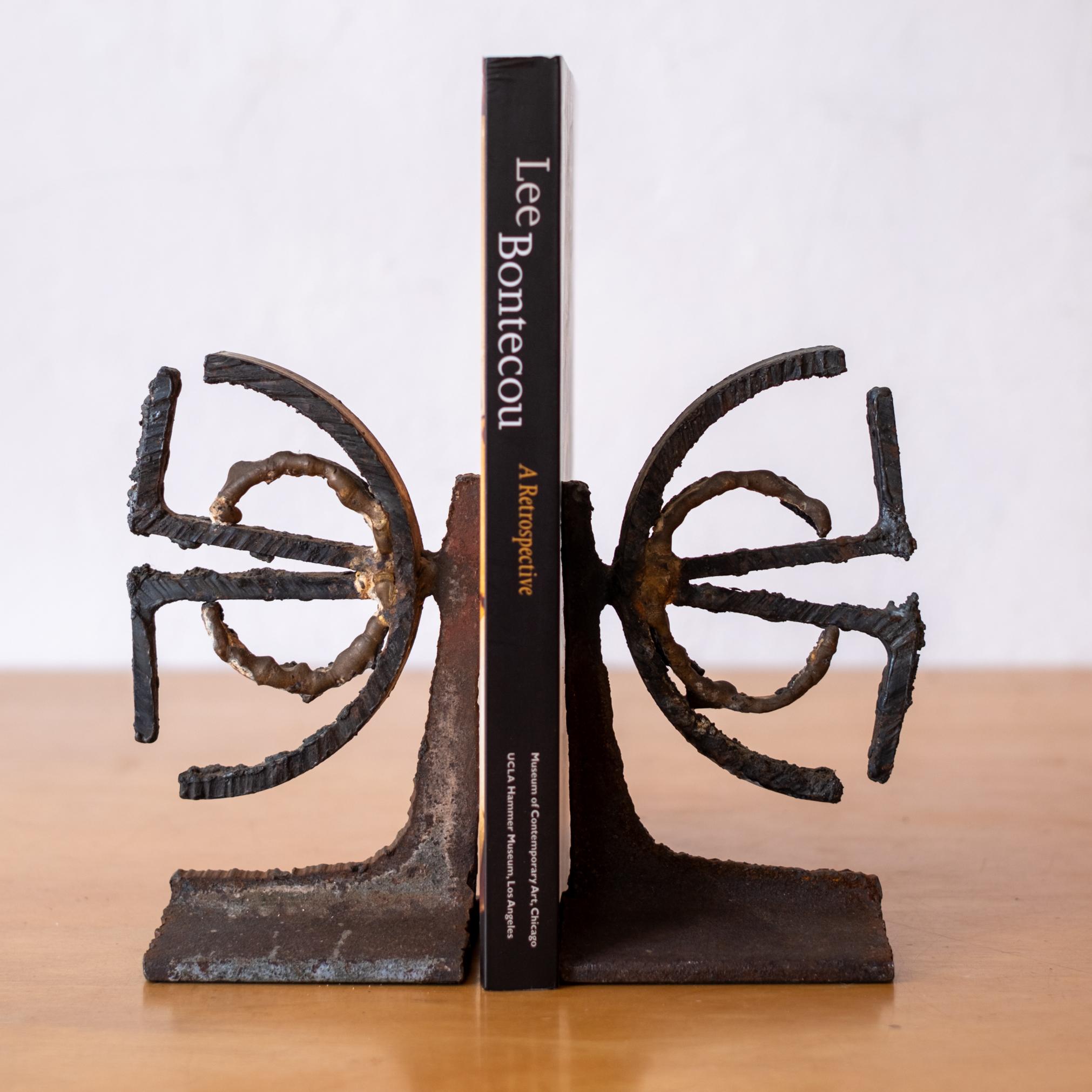 A pair of sculptural torch cut steel bookends. A substantial pair of artist made solid metal bookends, 1970's.