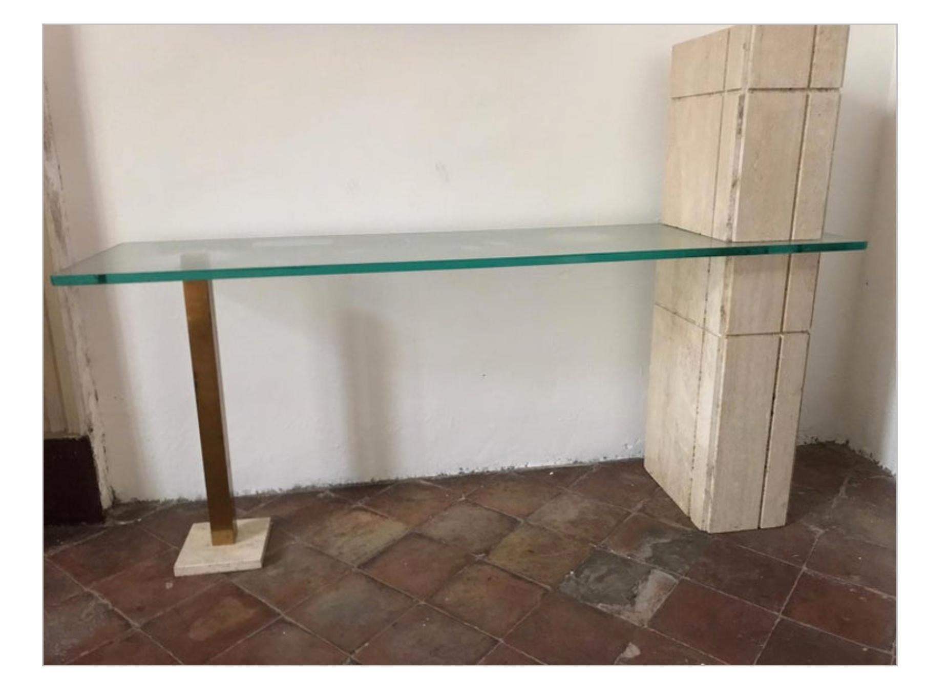 Sculpture console table with travertine and brass pedestals and rectangular glass top

Travertine pedestal cm 92 H.