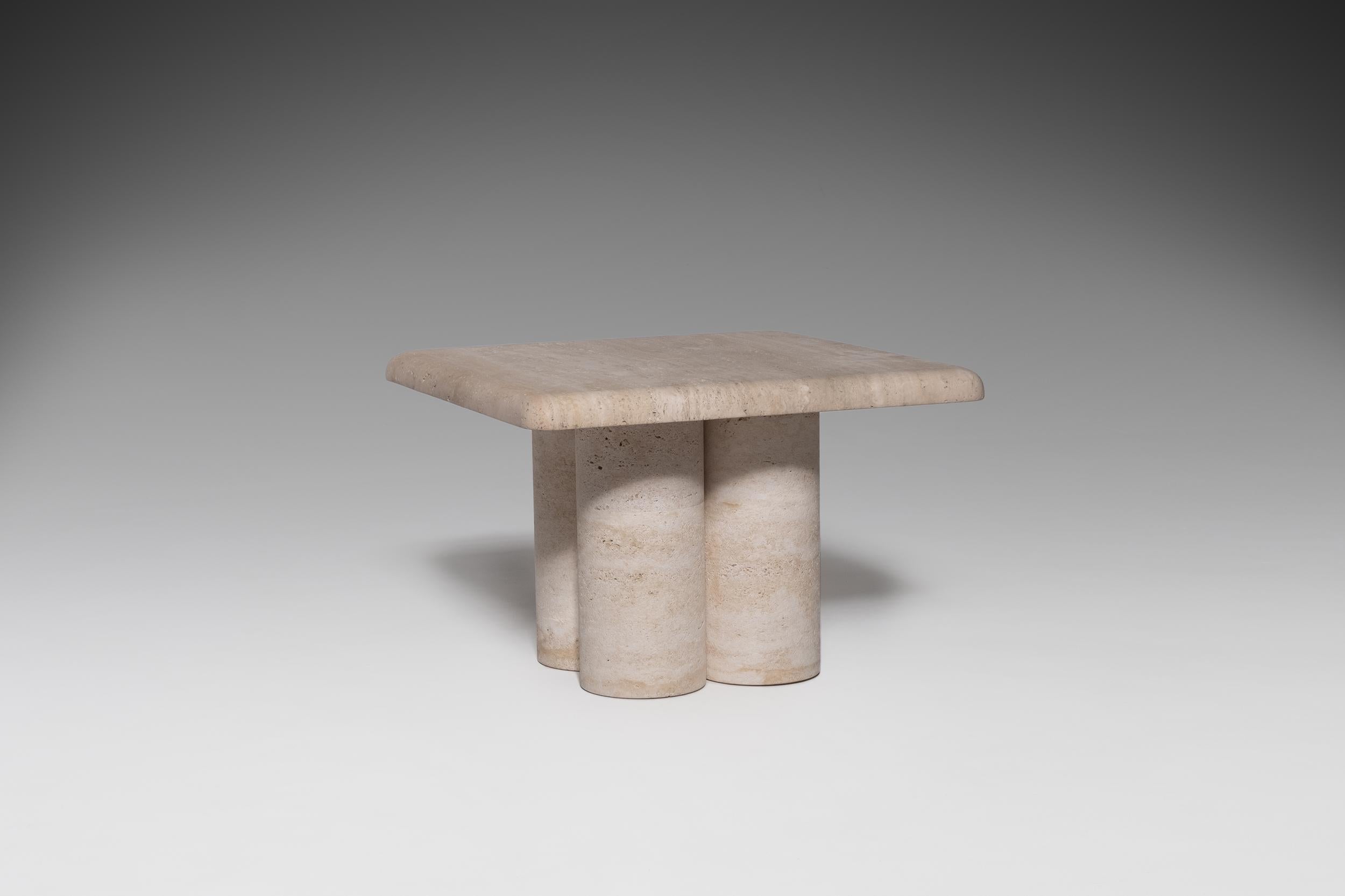Sculptural travertine side table in the manner of Bellini, 1970s. Very distinctive 'bulky' design composed of a heavy 4 cm thick square table top on a 'column base'. Base is composed of four cylinder columns (mounted together) with a nice refined