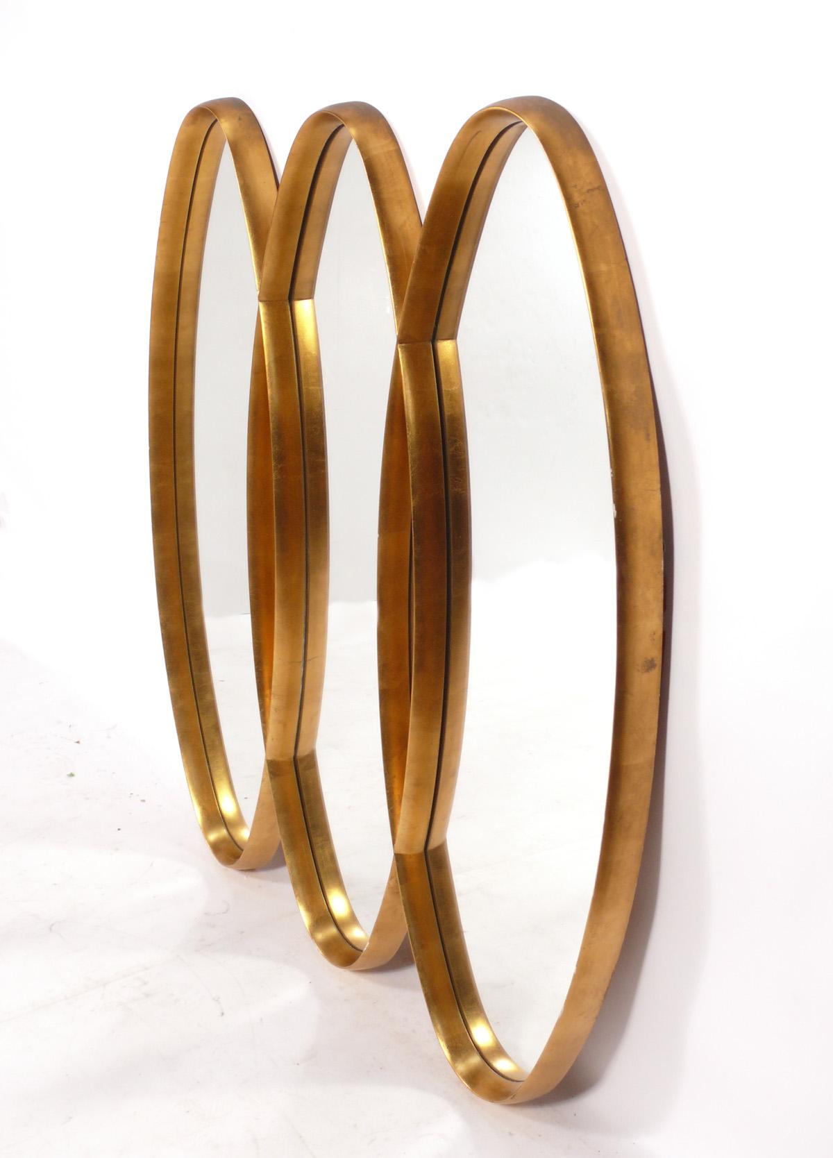 Sculptural triple oval gilt mid century mirror, American, circa 1960s. Retains warm original patina to the gilt frame.