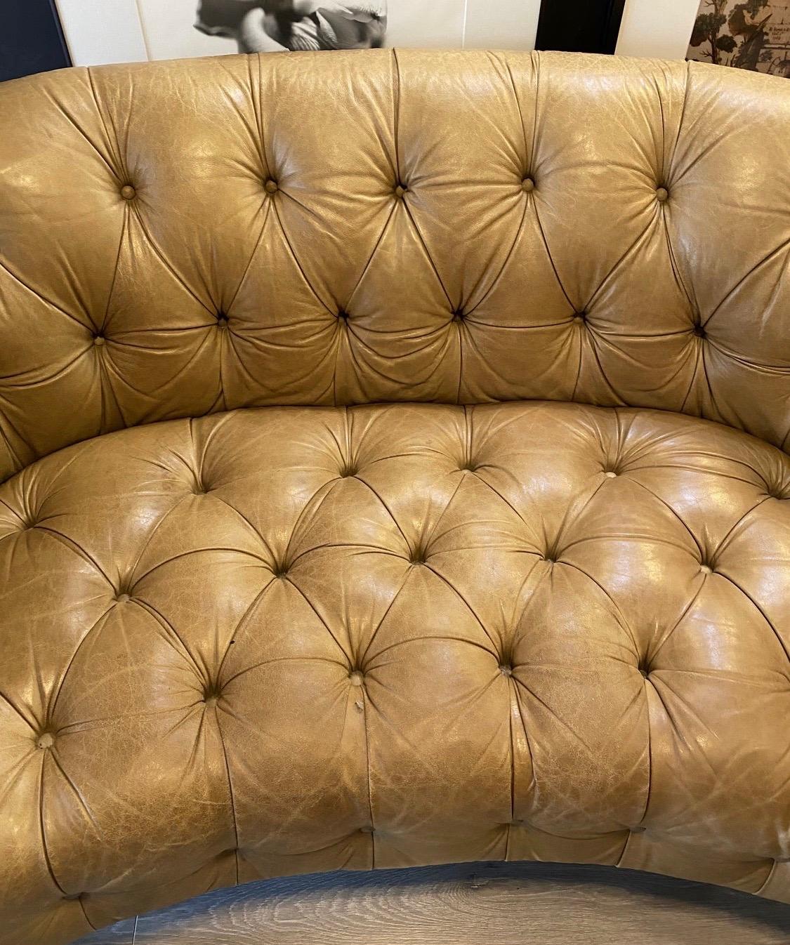 Iconic Chesterfield vintage sofa that was made in Italy and is hallmarked as such. It is unusual to see the coveted curvature in the design of a Chesterfield sofa, they are normally straight. The leather on this piece is soft and gorgeous with a