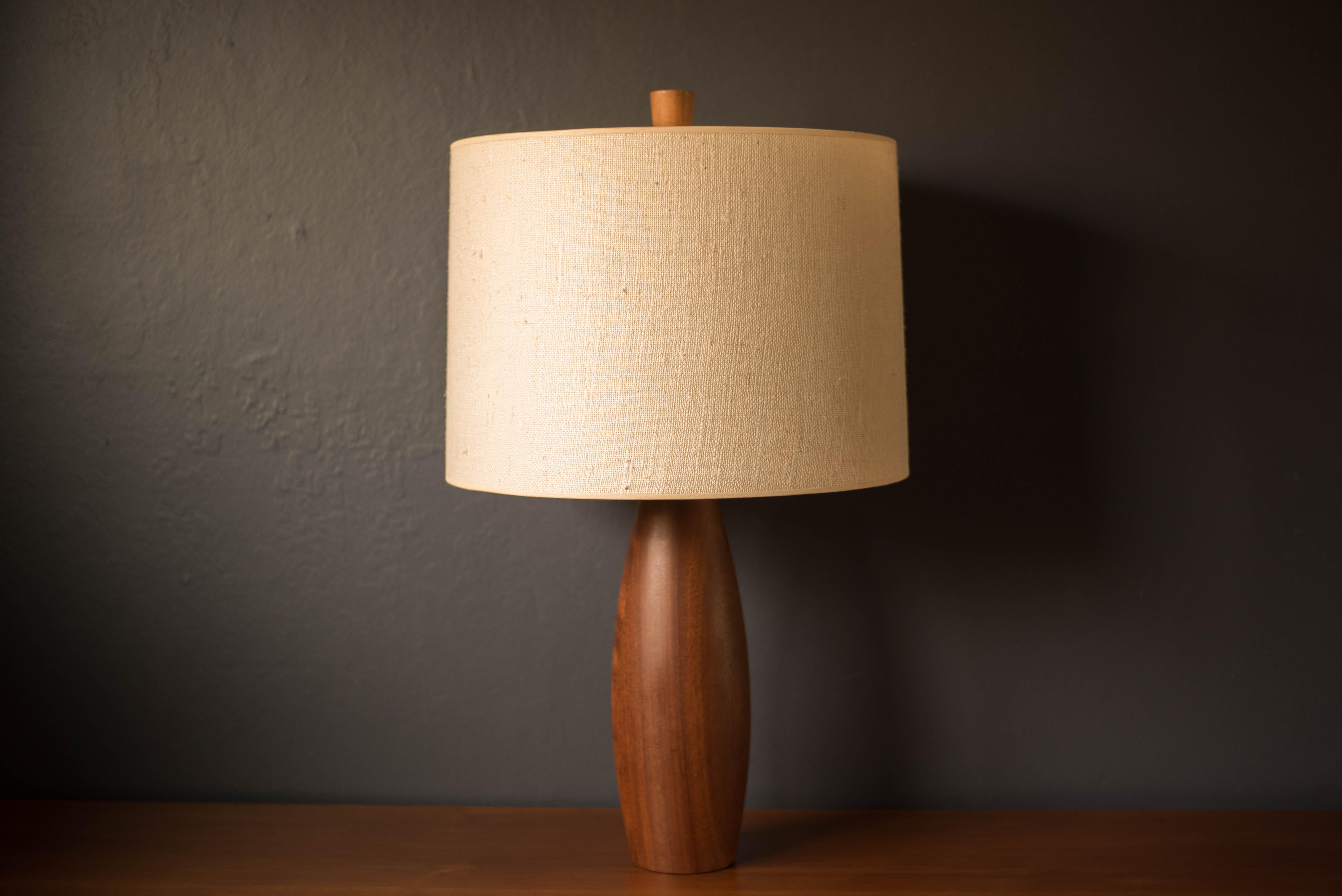 Vintage Scandinavian solid teak turned accent table lamp, circa 1960's. Features a sculptural base displaying natural warm wood grains and features a 3-way switch mechanism. Drum shade, harp, and finial not included. 





Offered by Mid Century