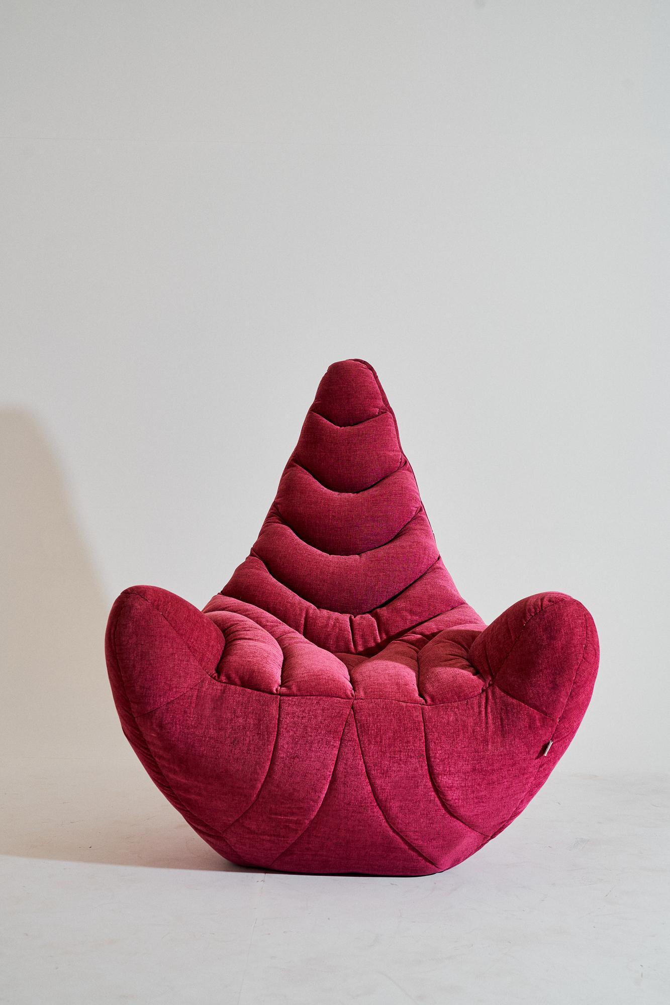 Contemporary, upholstered fiberglass armchair - Popcorn Armchair by Kunaal Kyhaan. The sensual form, is imagined in a royal pink plush upholstered form. Layers of fiber are hand moulded by traditional sculpture artisans and perfectly shaped to