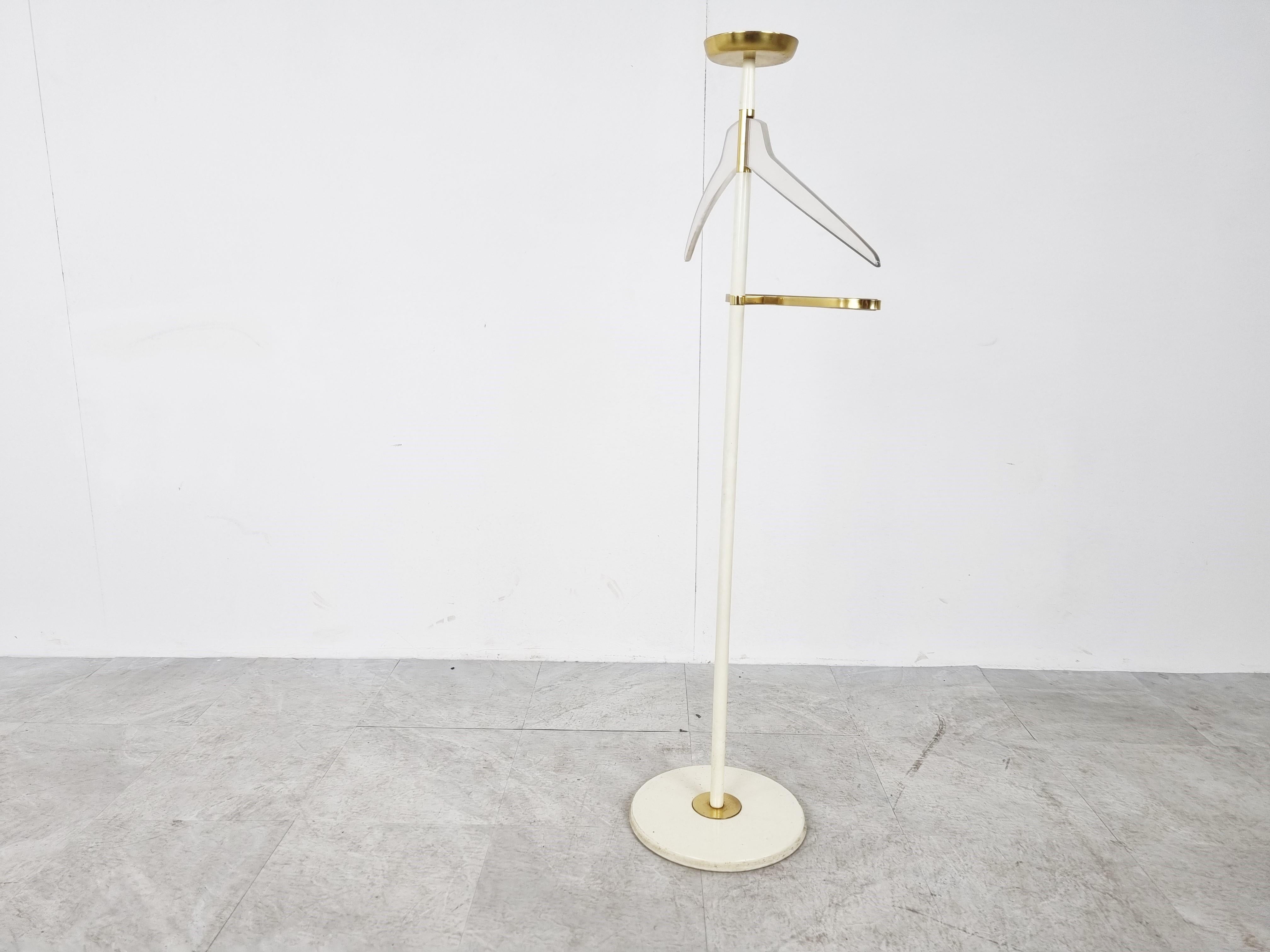 Mid century clothes valet/dressboy made by Vereinigte Werkstätten.

It is made from a white enamelled frame, a brass and leather pants hanger with lucite coat hook and topped with a brass vide poche.

Very decorative and useful item.

Good
