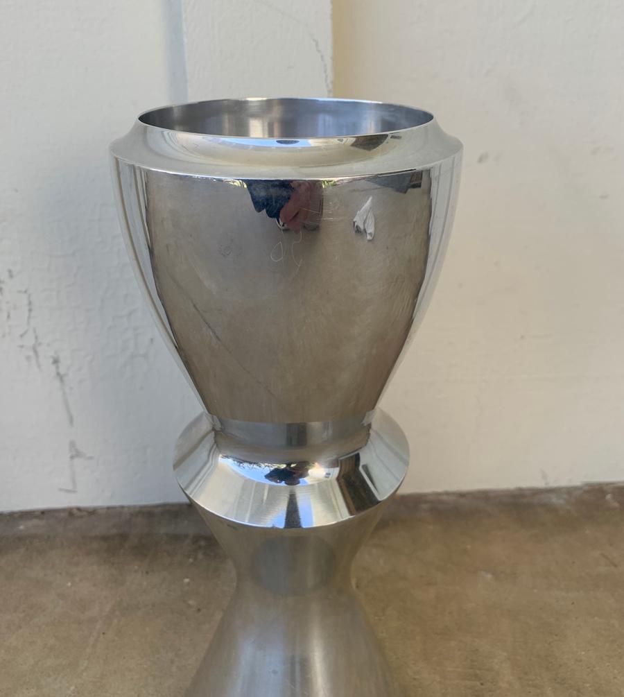 The symmetrical silhouette of the vase suggests architectural elements of another century. This vase possesses a monumental and timeless presence, a fine complement to a formal room. 

Heavy, solid piece, measures 11