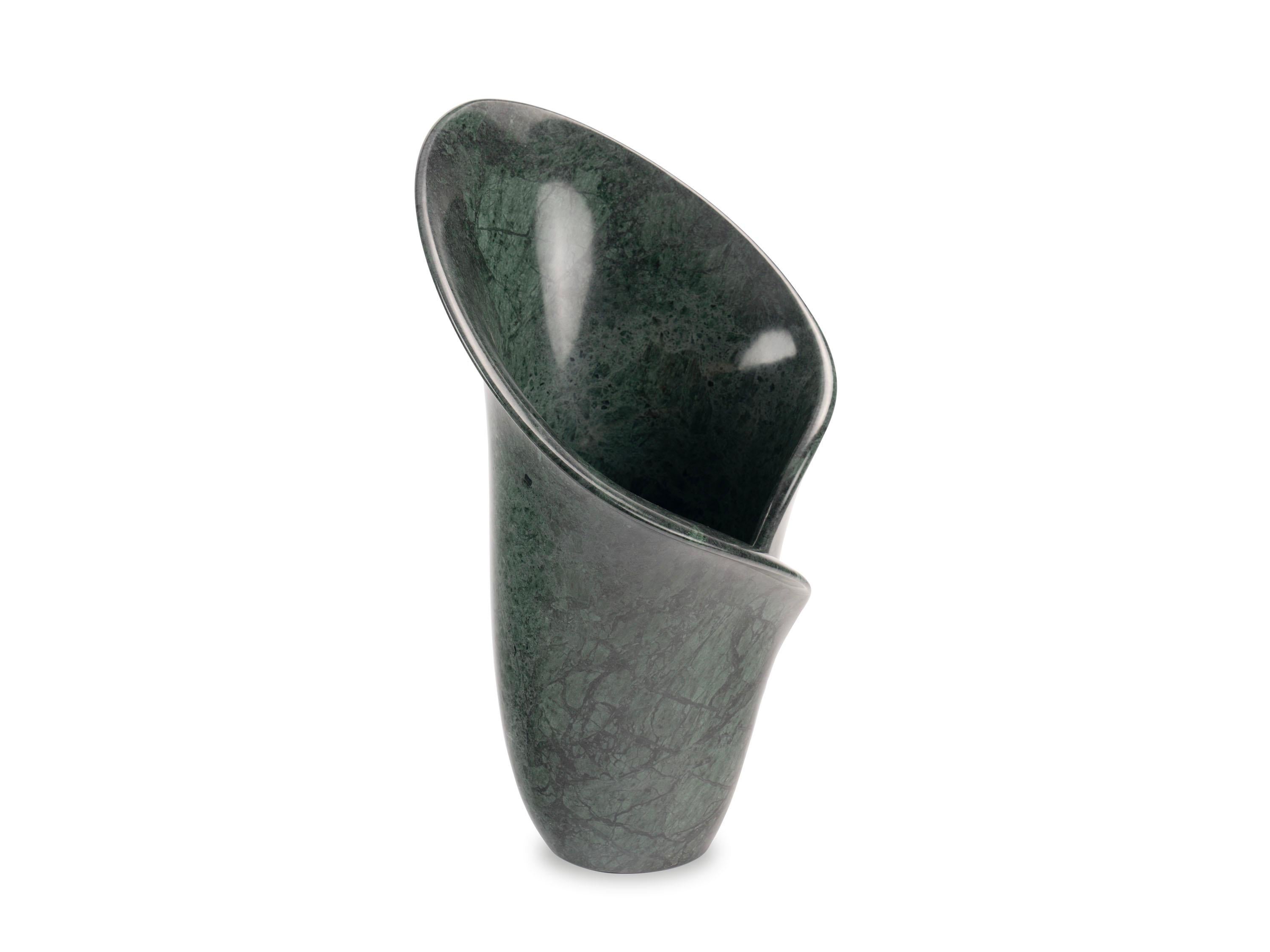 This sculptural vase is inspired by the elegant shapes of the calla lily, a flower known for its beauty and symbolism. Hand-sculpted from a block of imperial green marble, this piece highlights the natural beauty of the marble. The polished surface