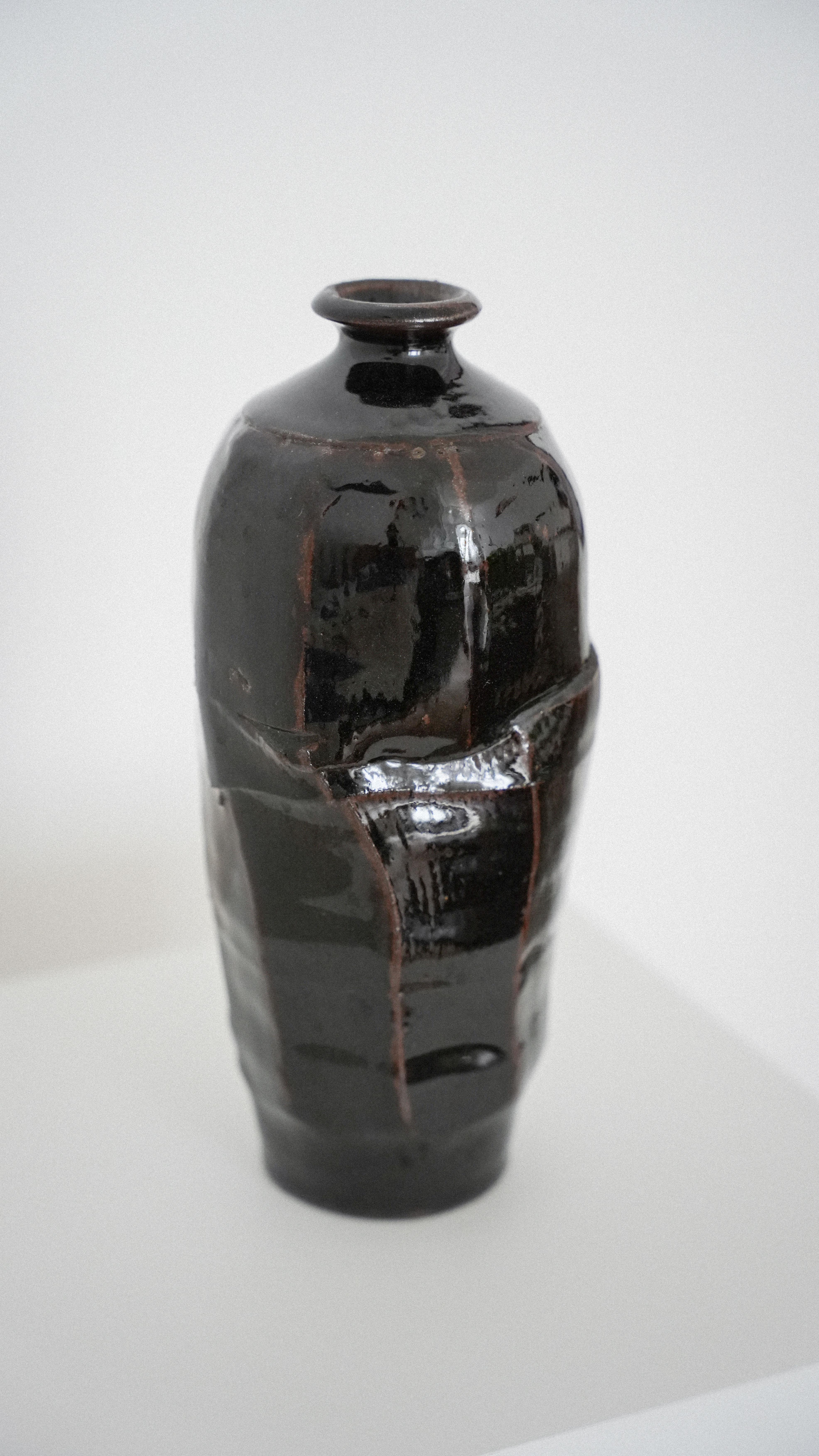 Sculptural handmade vase with dark brown Japanese Tenmoku glaze by a London-based potter.