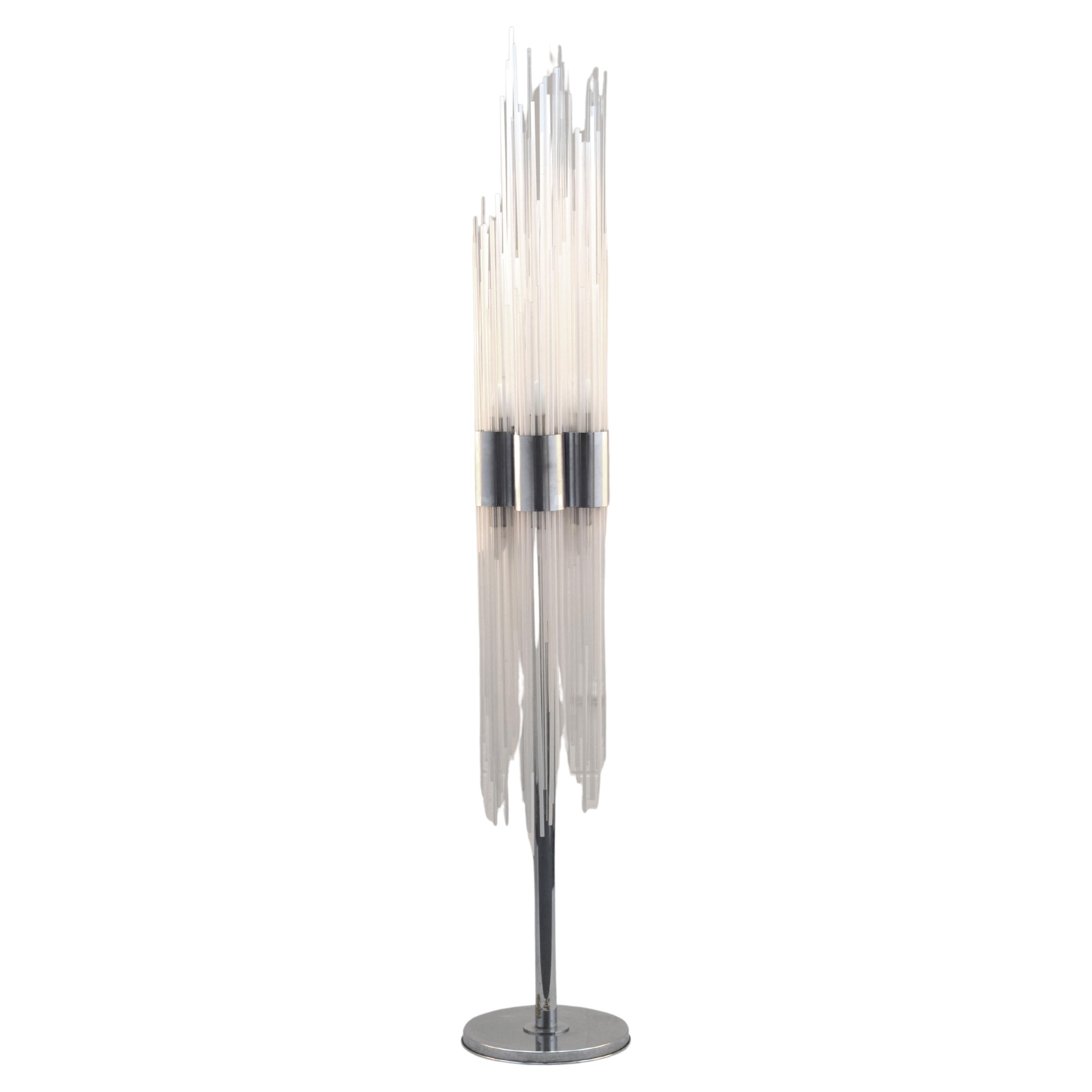Extraordinary rare sculptural 1960's Venini floor lamp made of around 100 reeded Murano glass strands, set in a irregular formation of white and clear glass rods, vertically inserted into chrome rings that are attached to the chrome stand. The glass