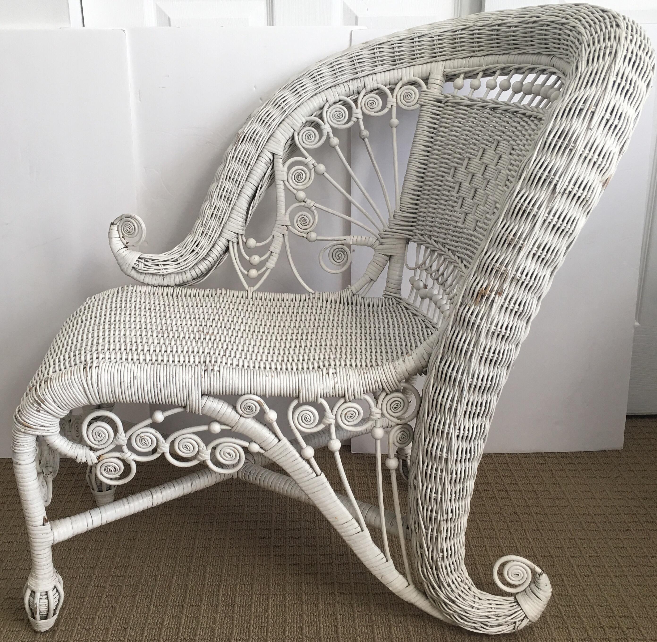 Victorian style white one-arm wicker portrait chair. This unique and sculptural lounging chair is the perfect accent piece for any space including a bedroom, living room or even in a large bathroom or walk-in closet. This chaise lounge style chair
