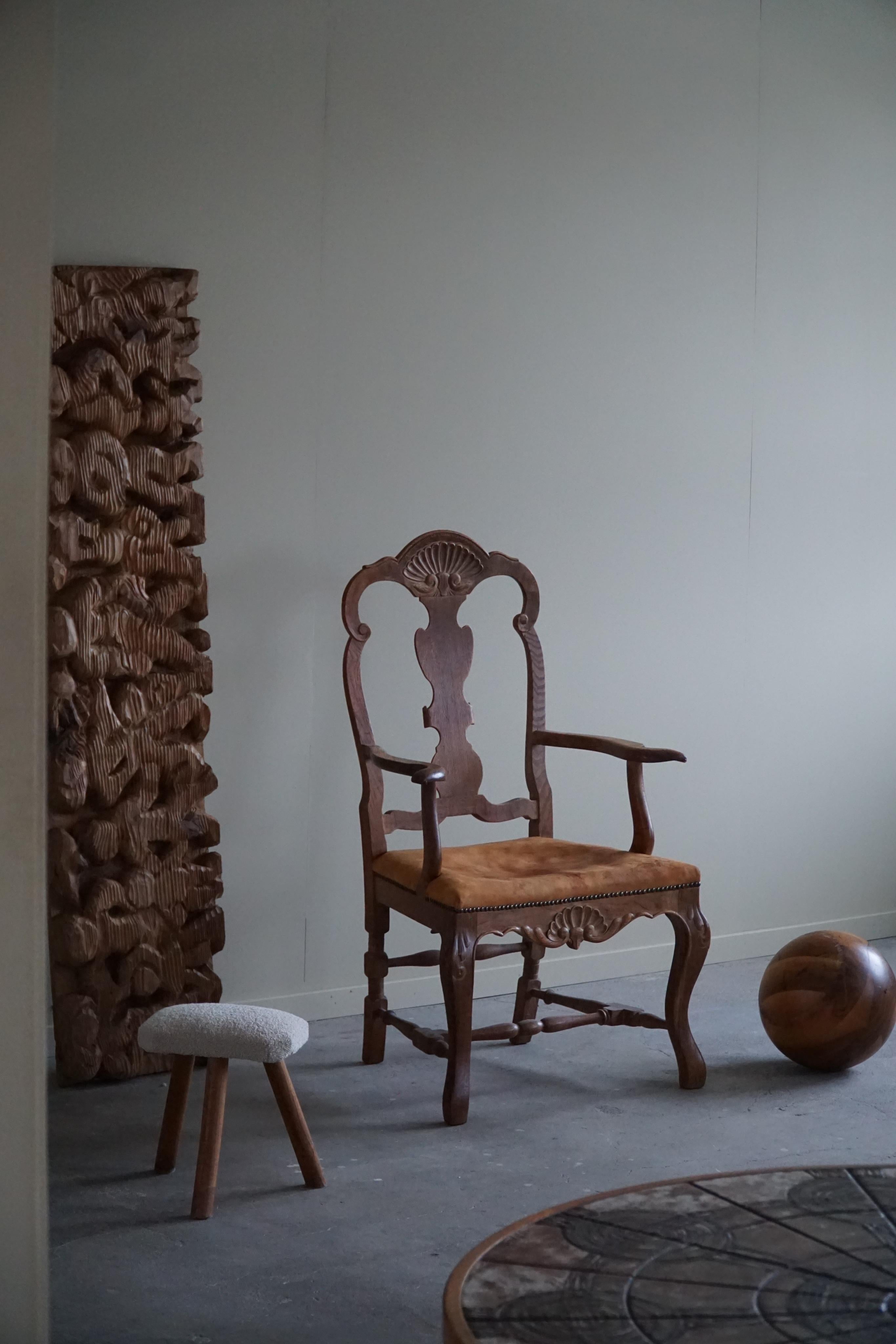 A sculptural armchair in oak and leather seat. Made by a Danish Cabinetmaker in the 1940s. A decorative figure for the modern interior. This armchair / deskchair have a really strong impression that pairs well with many types of interior styles. A