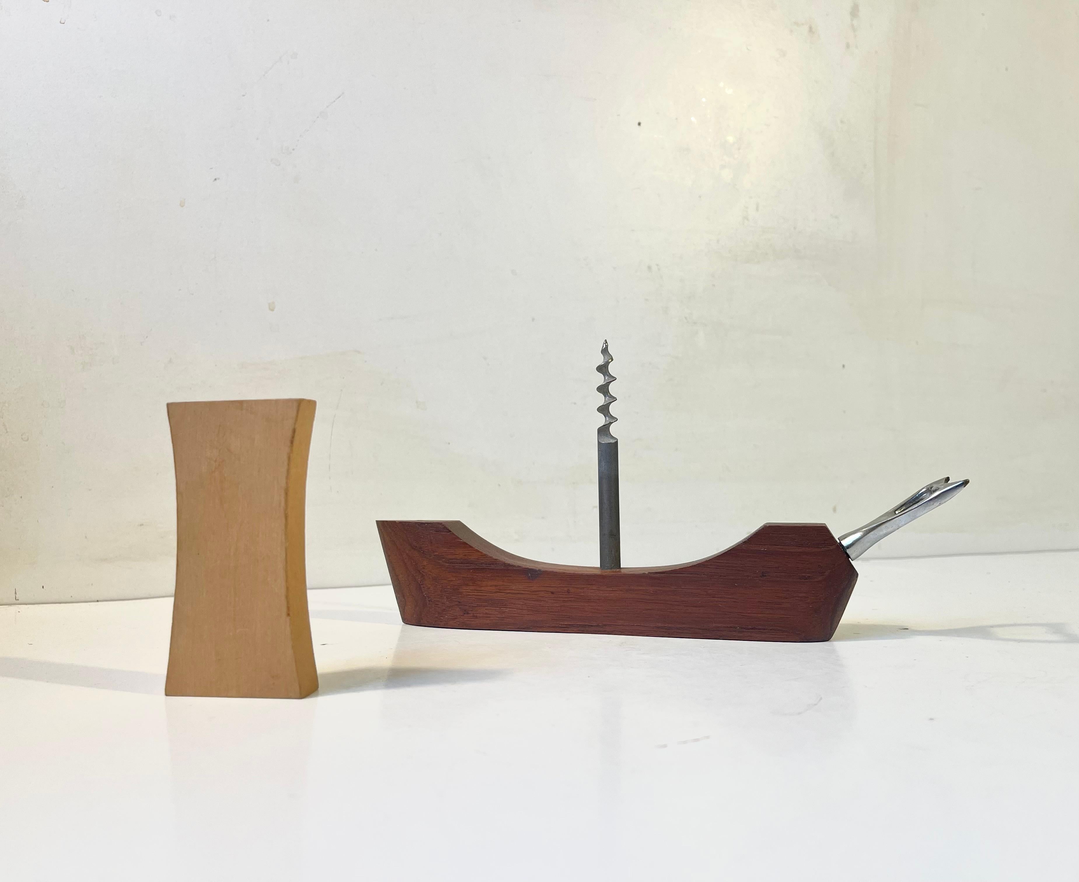 Beautiful handmade, sanded and polished solid teak and white beech viking ship. Two functions incorporated: boat bottle opener and a corkscrew hidden within the sail. It was designed in Denmark during the early 1960s and was among other distributed