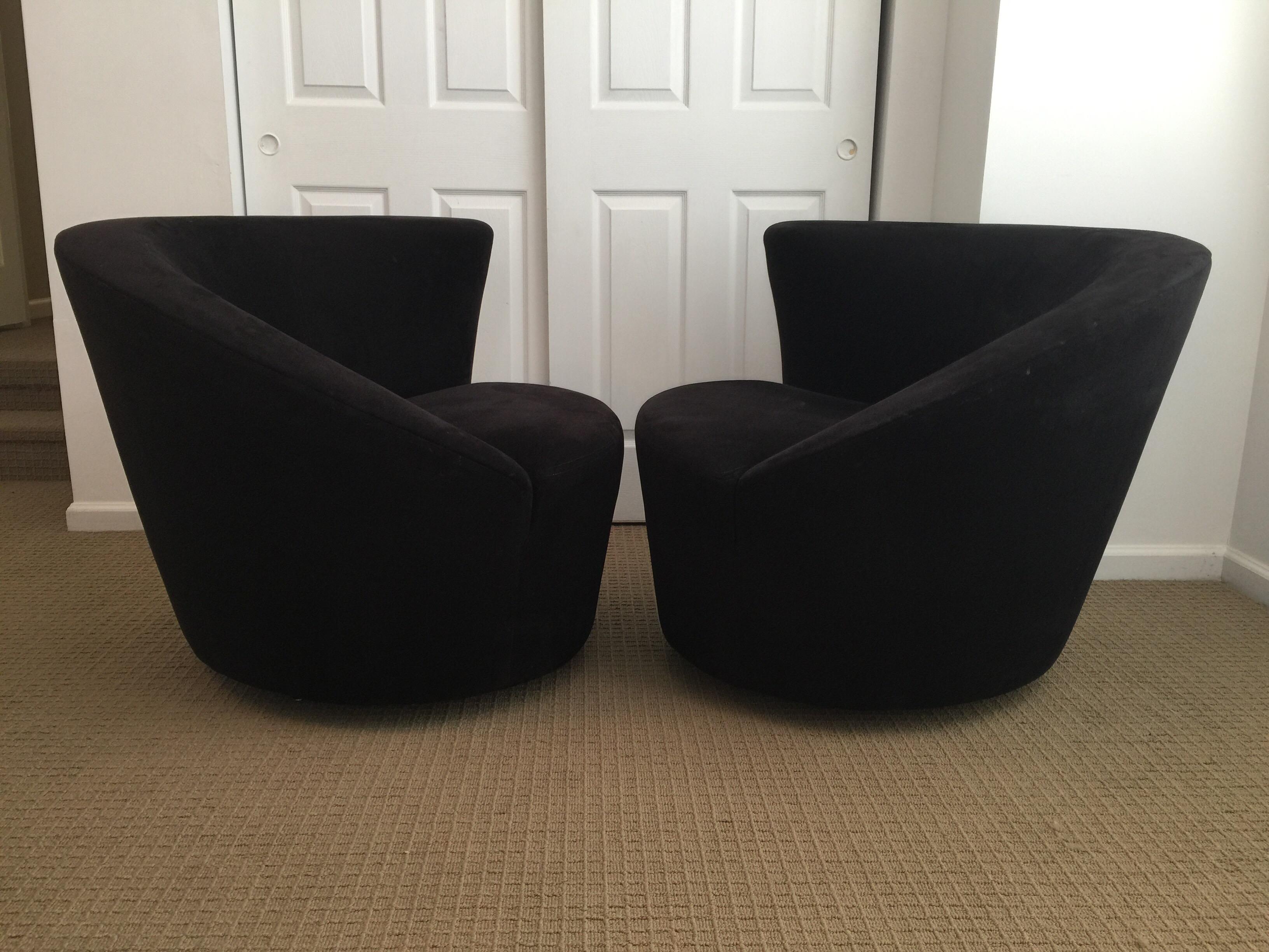 Set of two gorgeous swiveling corkscrew lounge chairs in original black ultra suede fabric by Vladimir Kagan for Directional. The unique asymmetrical design of these biomorphic Nautilus shaped club chairs features a curved and swooping back line