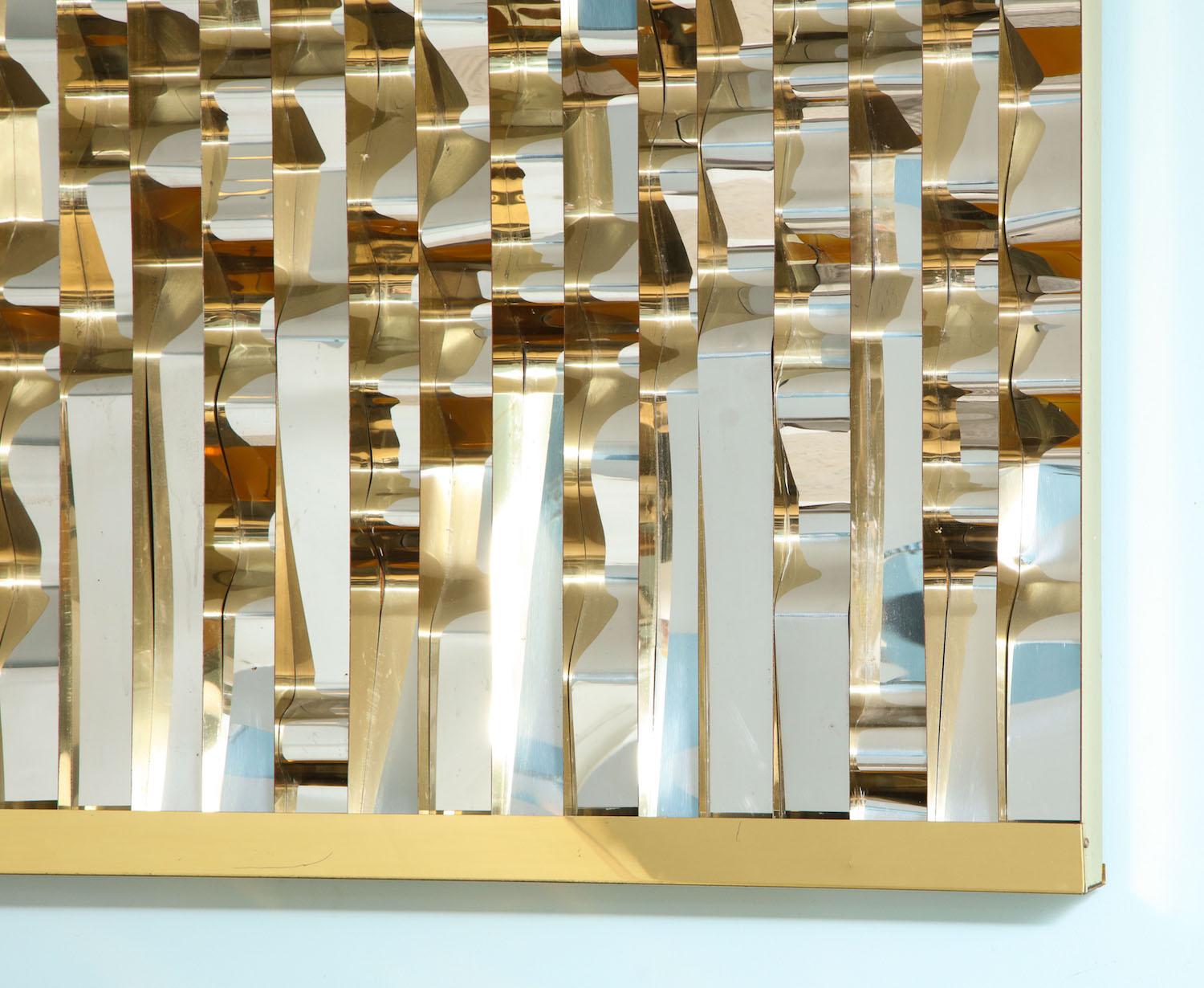 Rectangular shaped wall sculpture divided into vertical sections with undulating strips in brass and chromed steel. A bold statement. Signed.