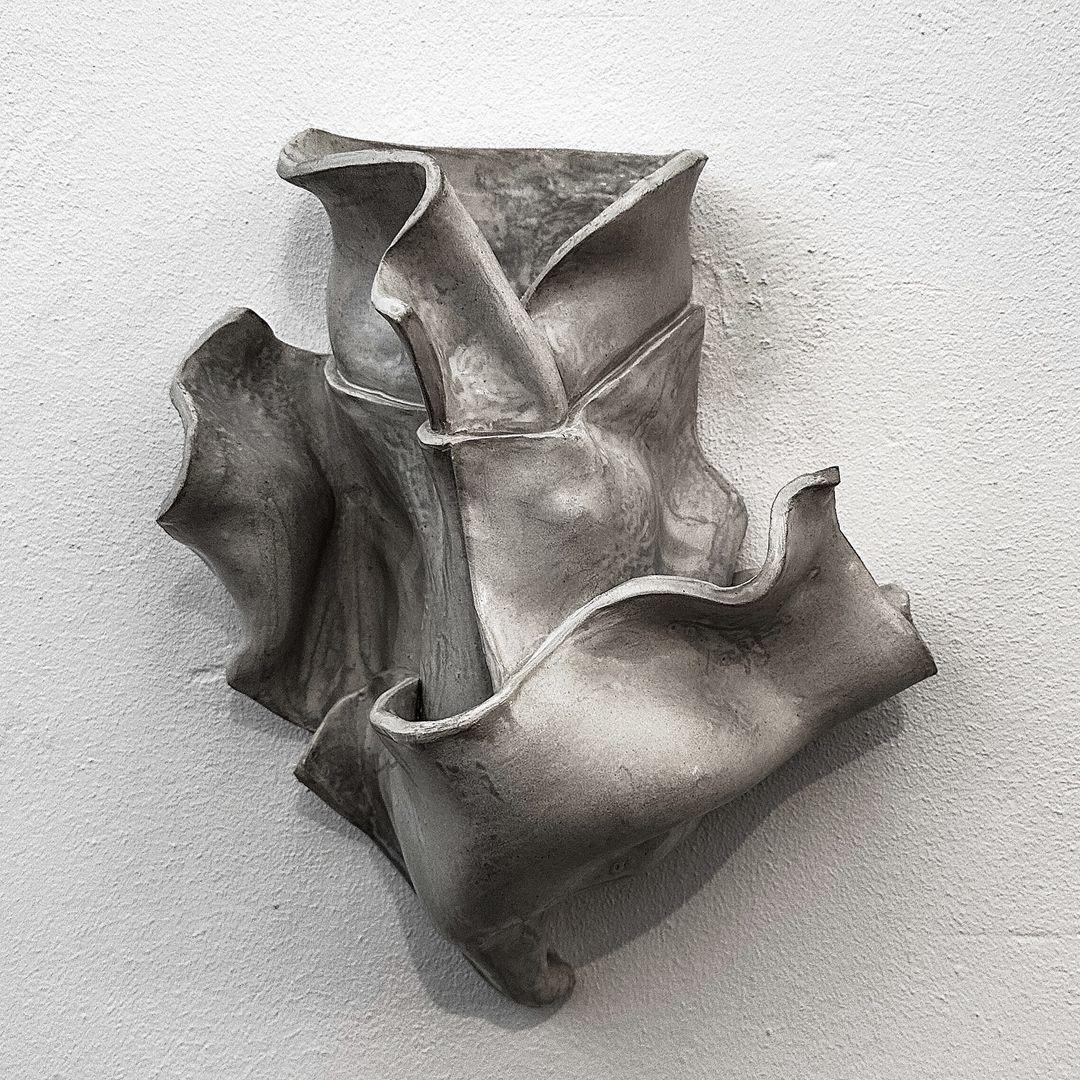 Sculptural Wall Vase I by Alexandra Madirazza
Dimensions: W 35 x D 25 x H 35 cm (These are approximate measurements)
Materials: Stoneware
Also available in brown, white or gray glaze. Matt or glossy.

Alexandra is an architect, but for the past 5