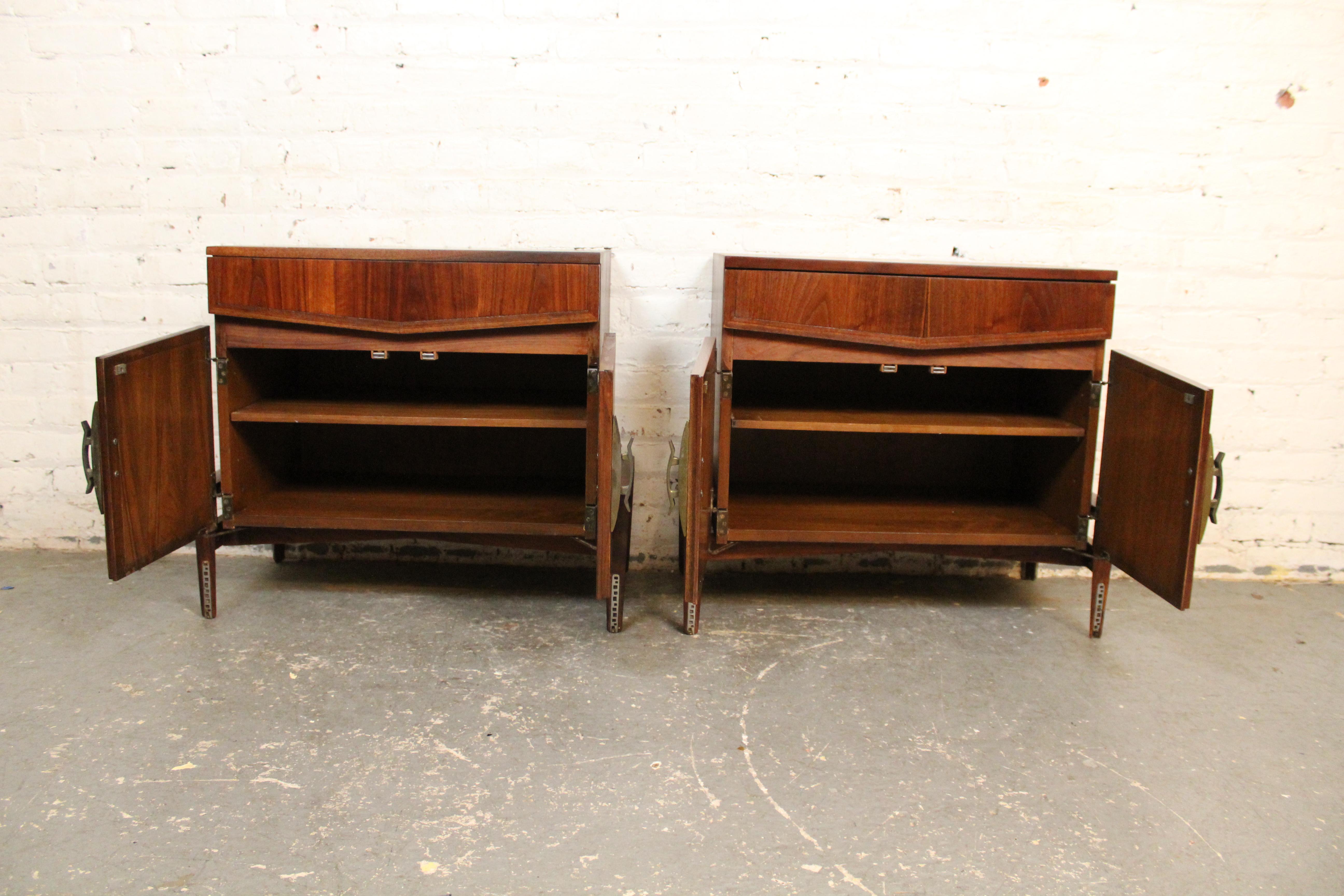 Exquisite mid-century vintage nightstands designed and manufactured by New York's Helen Hobey Baker brand. A robust sculptural silhouette showcases a heavy Chinoiserie influence with a spacious upper cabinet suspended over wide-based carved legs.