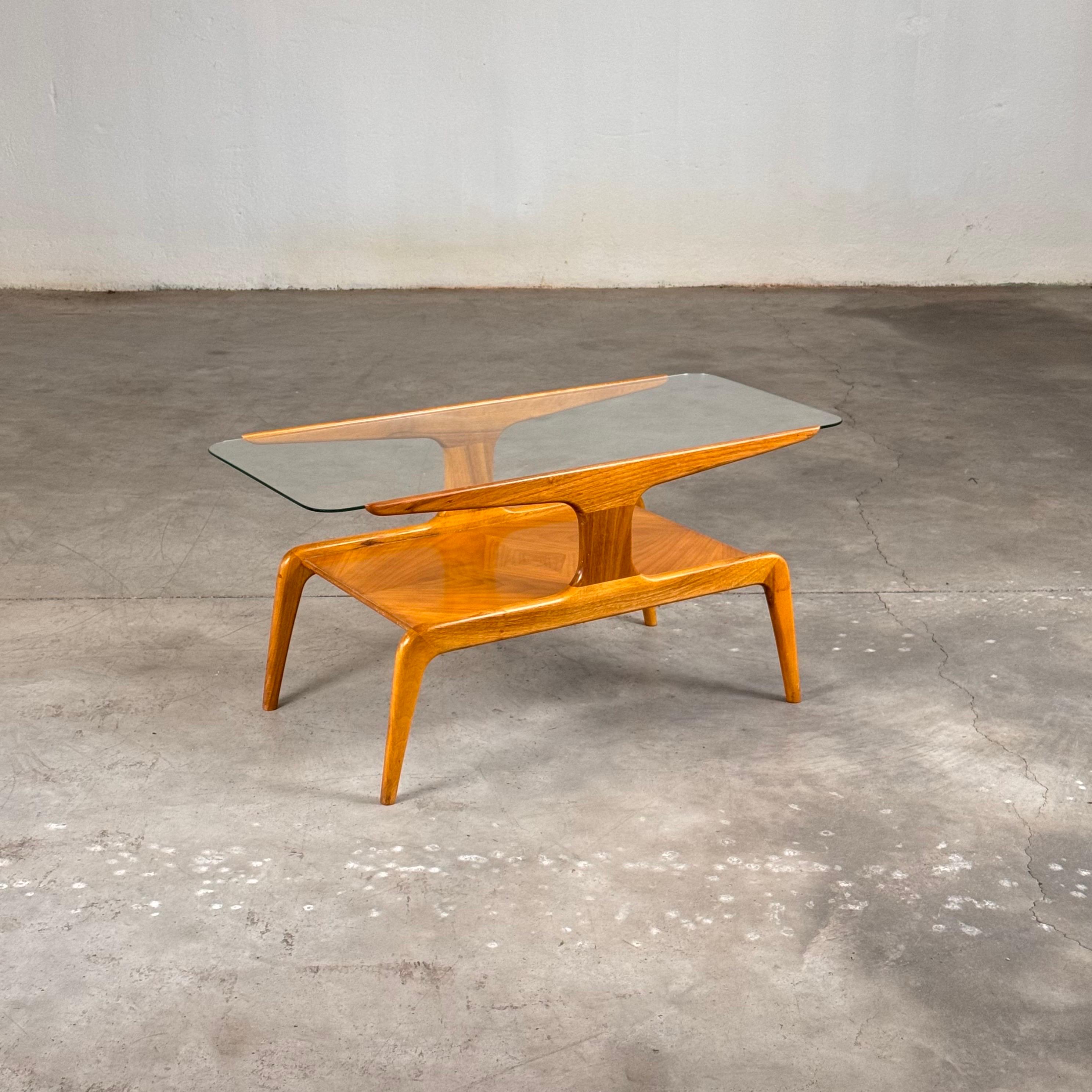 
This sculptural walnut coffee table, designed by the legendary Gio Ponti for Domus Nova in the 1950s, embodies the elegance and innovation that define mid-century Italian design. Originally featured in the La Rinascente concept store, this table is
