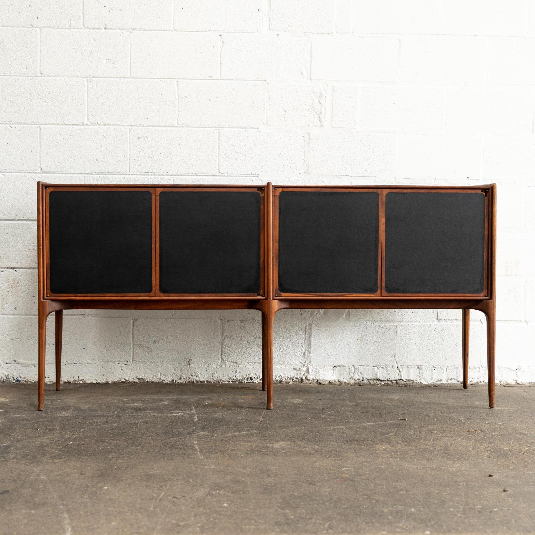 Unknown designer but likely American-made. Features large sections of solid walnut, hand-sculpted pulls, modular shelving, Italian-inspired legs, and record storage. This piece is priced with restoration in mind.
