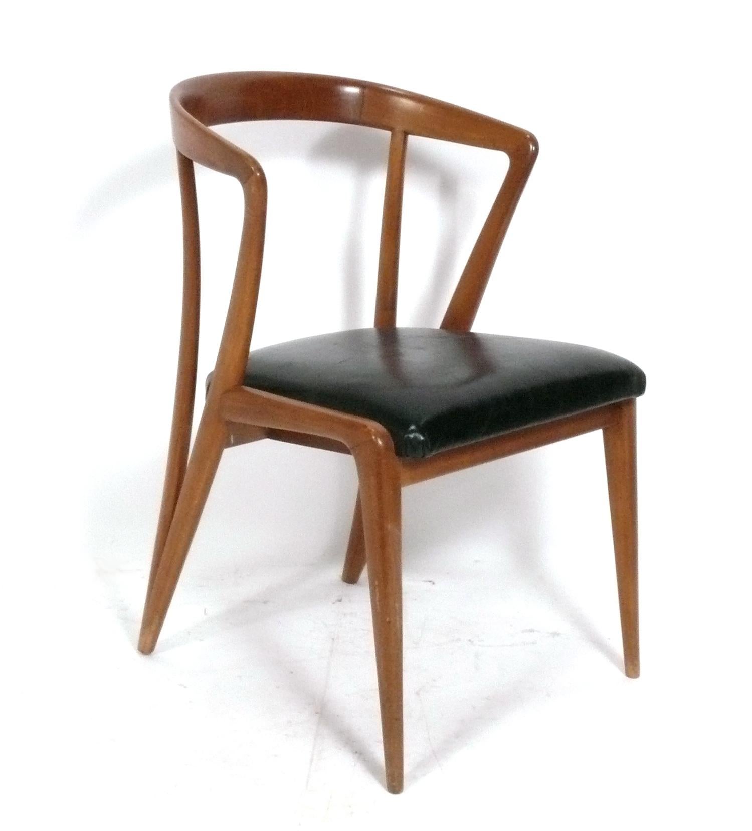 Set of sculptural walnut dining chairs, designed by Bertha Schaeffer for Singer and Sons, Italy, circa 1950s. Schaeffer designed these dining chairs along with his contemporaries Gio Ponti, Ico Parisi, and Carlo de Carli, all of which were made in