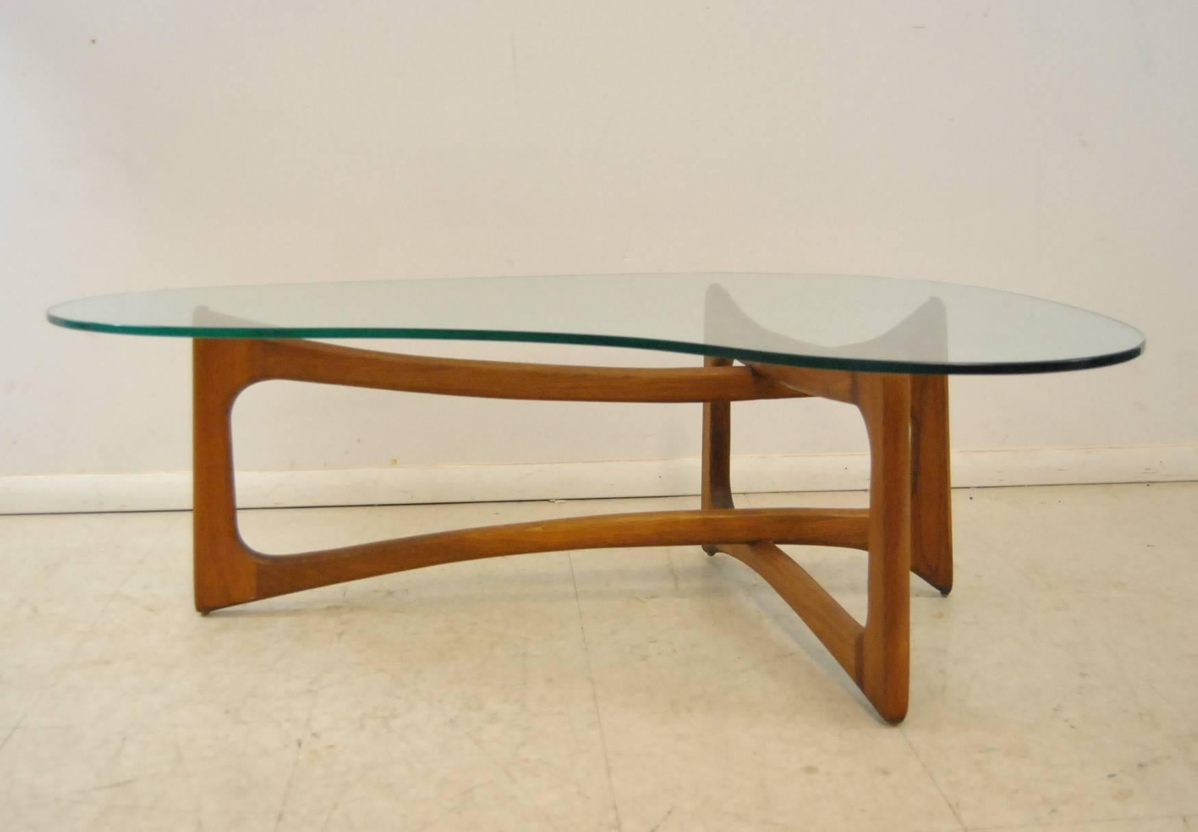 An iconic sculptural glass topped coffee table by Adrian Pearsall. This is the walnut base dog bone coffee table, model 2450-K from the 1960s.